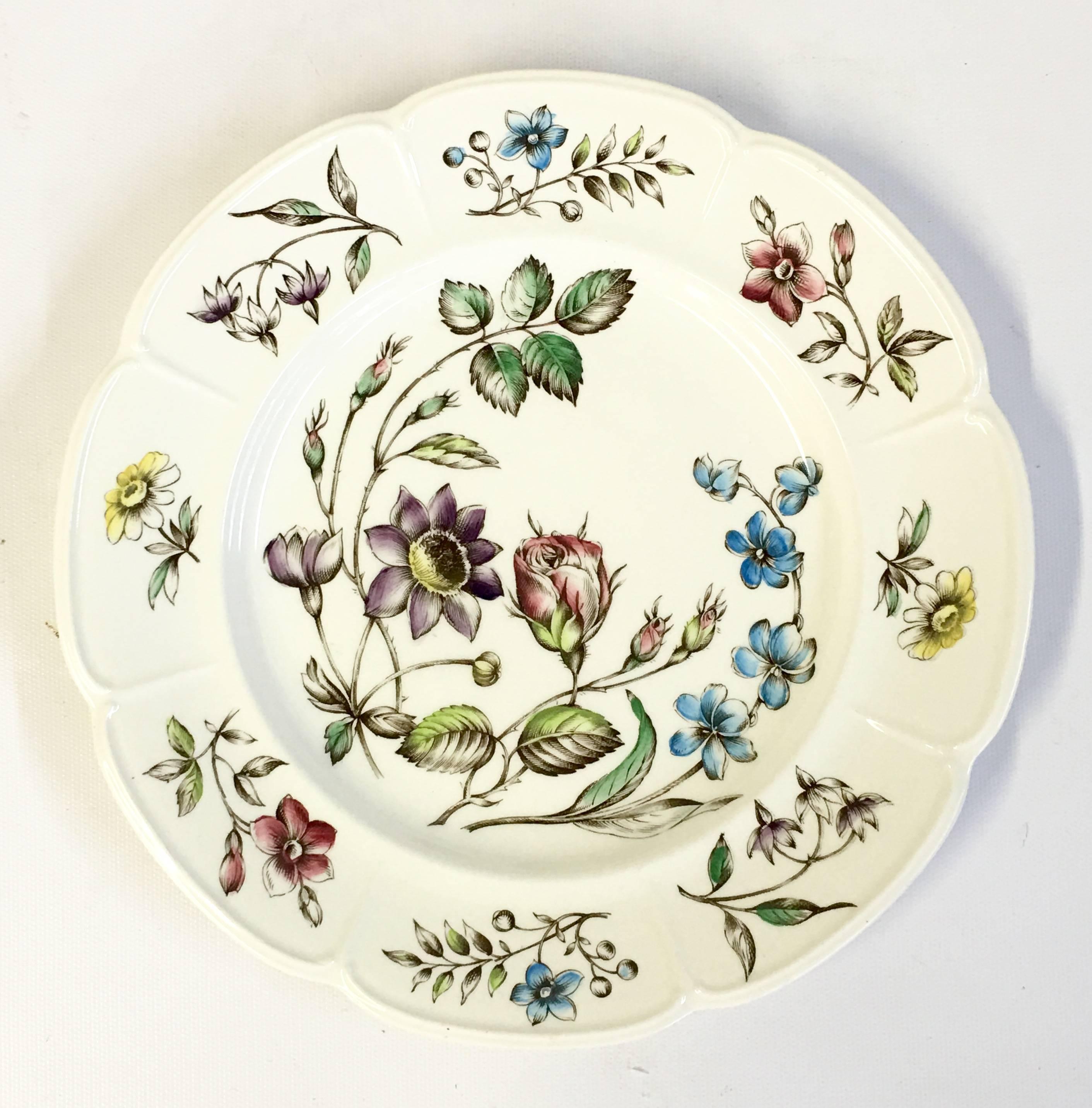 Mid-Century English Windsor ware ceramic plate set of 13 pieces. Beautiful floral pattern with a scalloped center and rim detail. Set includes, seven dinner plates and six salad dessert plates, 6