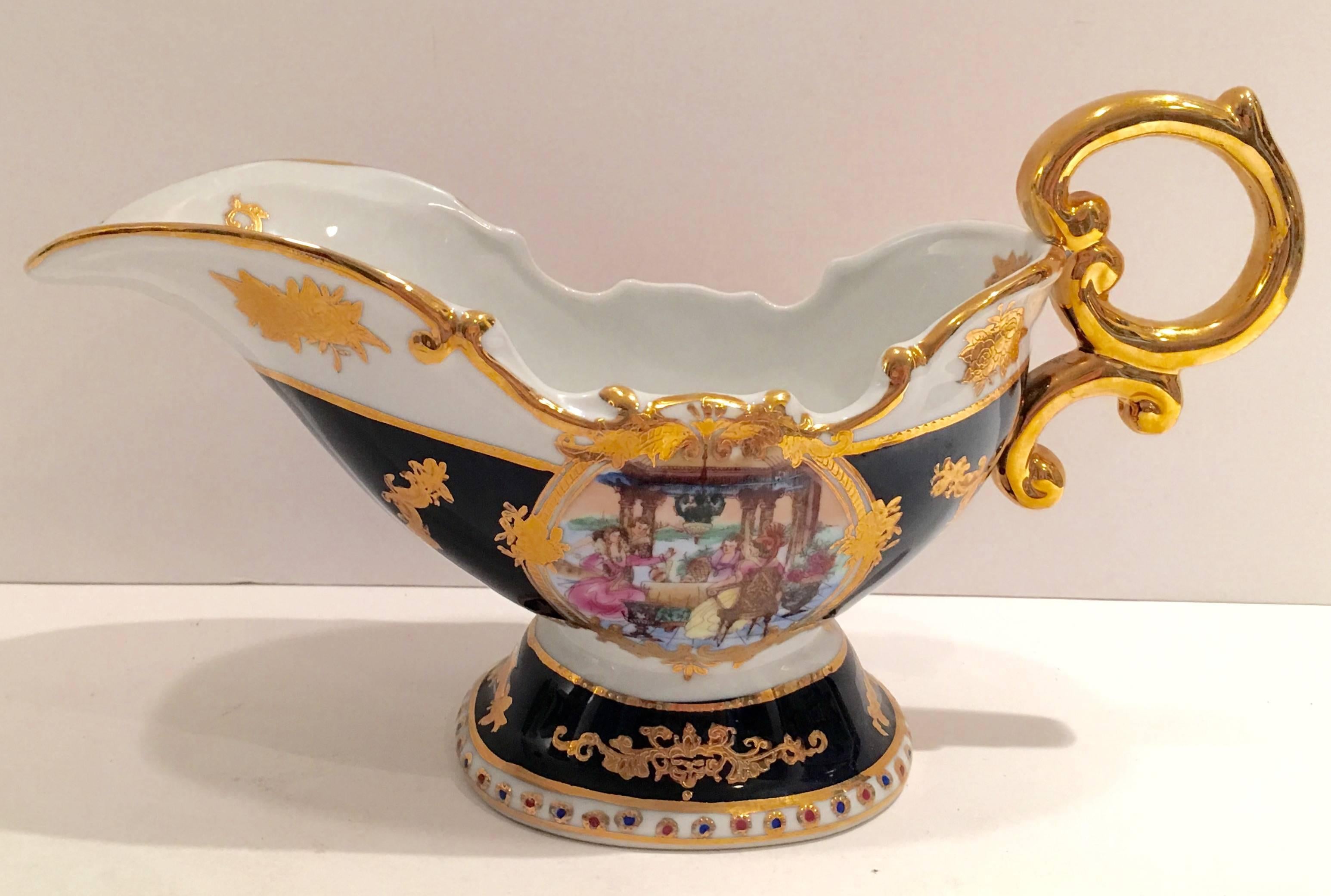French Sevres style monumental porcelain hand-painted cobalt with 22-karat gold decoration gravy boat. Features a double sided hand painted central 18th century group dining Al Fresco. Signed on the underside, L.F. Fine Porcelain Limoges-P.R.C.
  