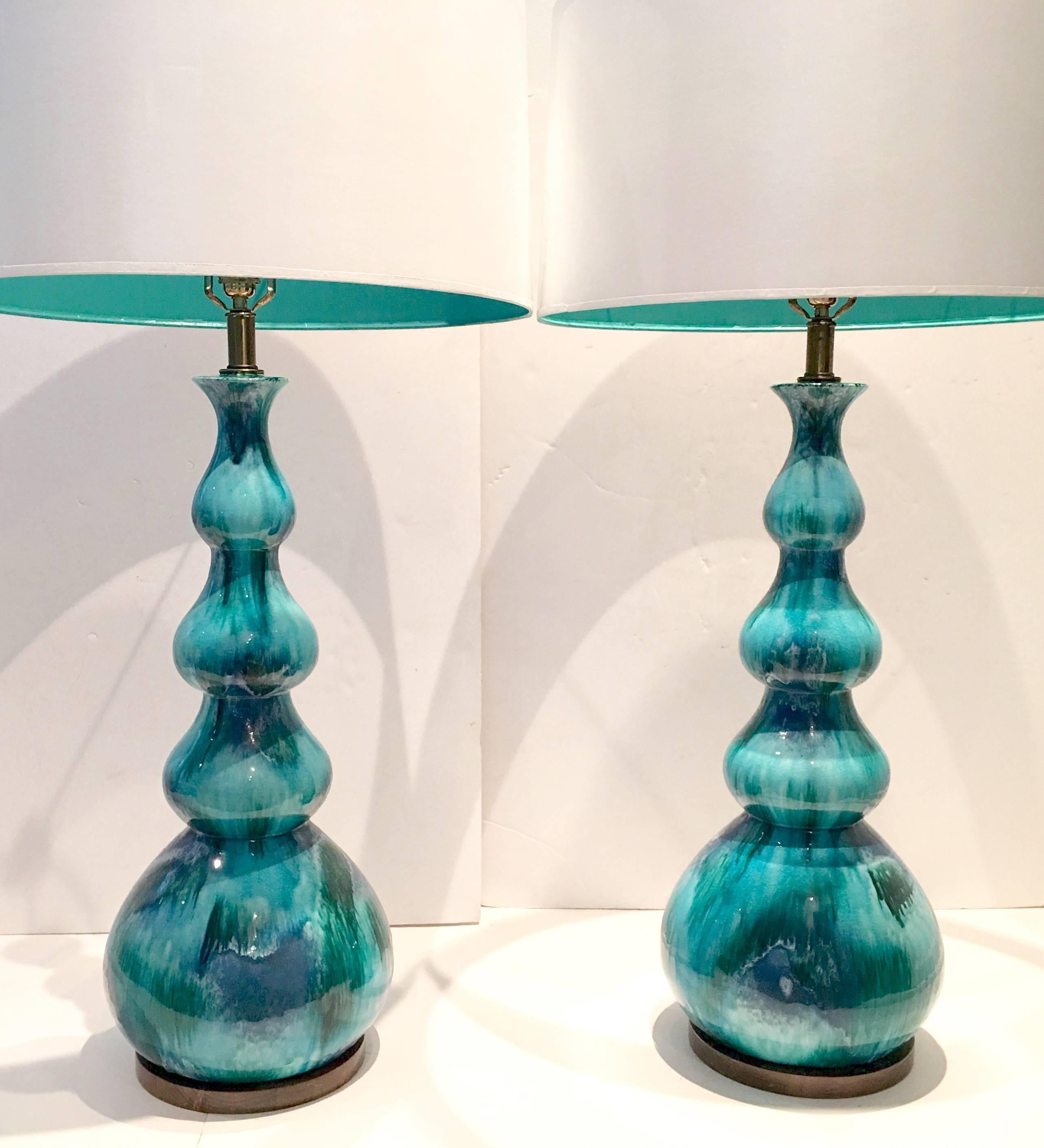 A Fine Pair Of Italian Turquoise Ceramic Glaze Four Gourd Form Tall Table Lamps Features  Vibrant turquoise with navy blue and kelly green tones, original walnut base and brass fittings. 
Wired for the US and in working order. Takes a single