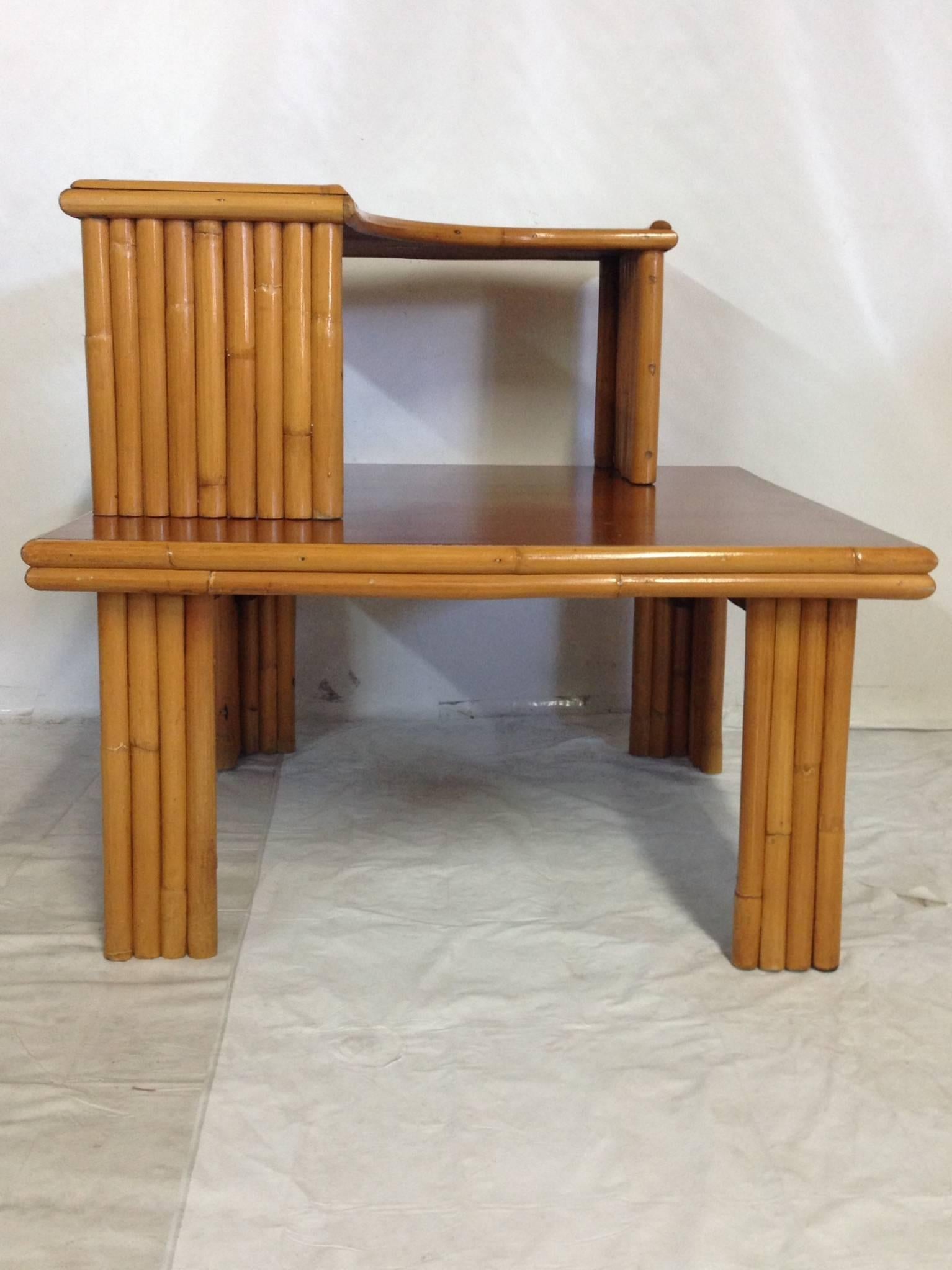 Paul Frankl designed, rattan two-tier, two-piece coffee or end table. Table tops finished in mahogany. Each piece is signed and numbered "Ritts Co. Tropitan Los Angeles 71R & 71J". Can be used indoors and outdoors. The top piece