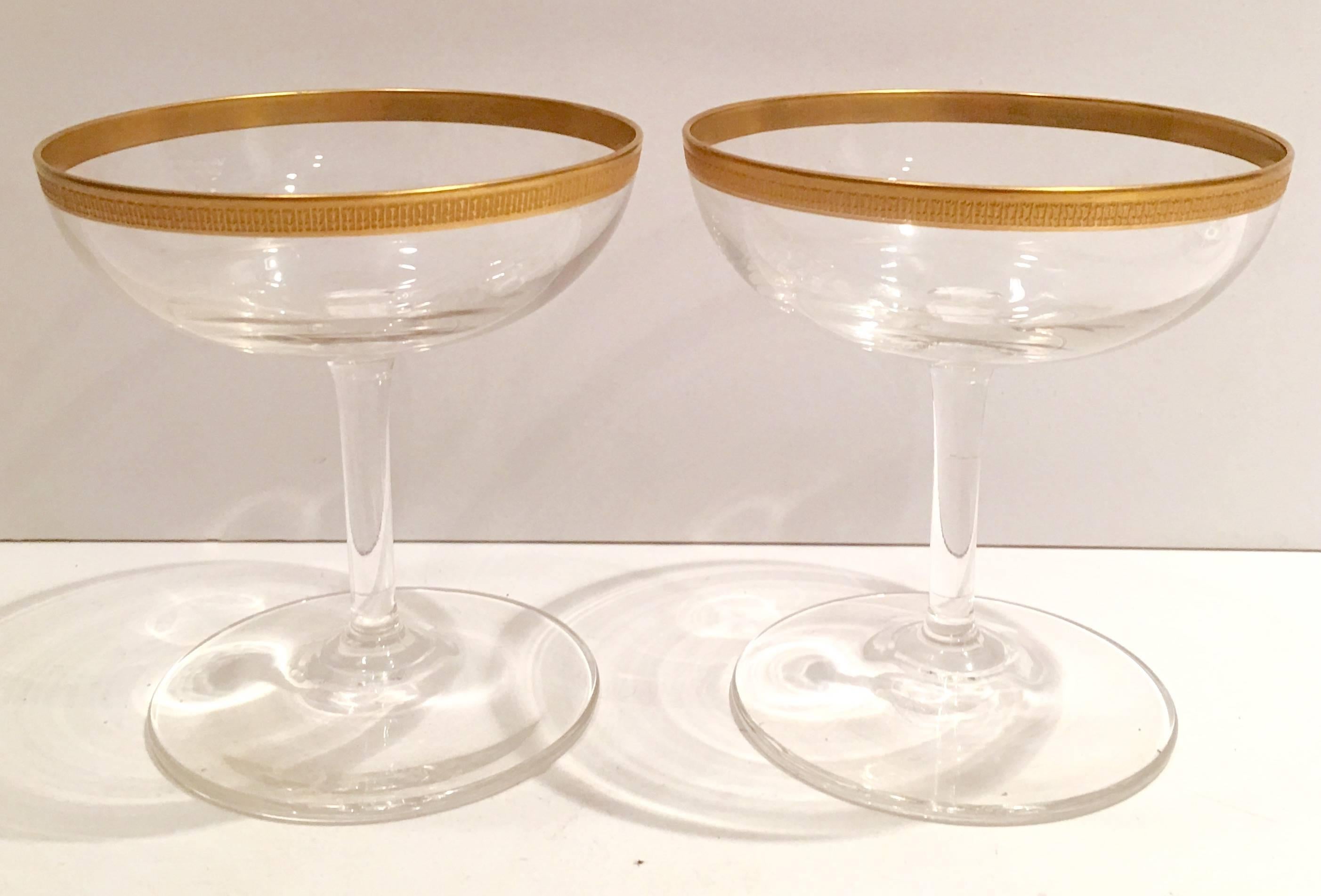 Hollywood Regency vintage set of twelve glass with 22-carat gold martini set. Set includes, eight crystal martini glasses with a 22-carat etched gold edge, one thumb print beverage pitcher with a 22-carat gold band and three-piece signed,