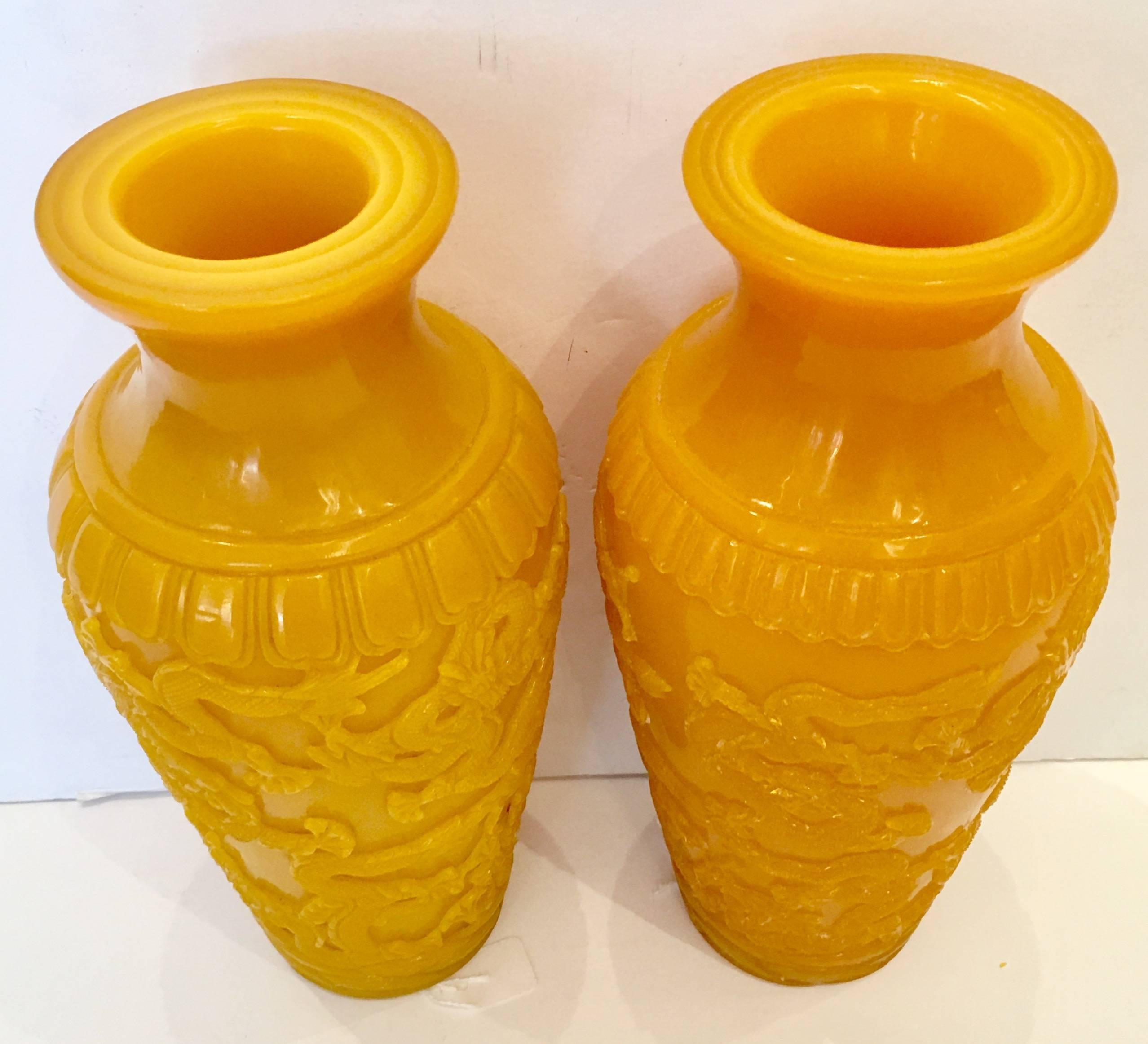 Rare pair of vintage Chinese Export Imperial yellow Peking carved glass high relief dragon motif vases. Slight variations between the two, one has a chop mark on the underside.
   