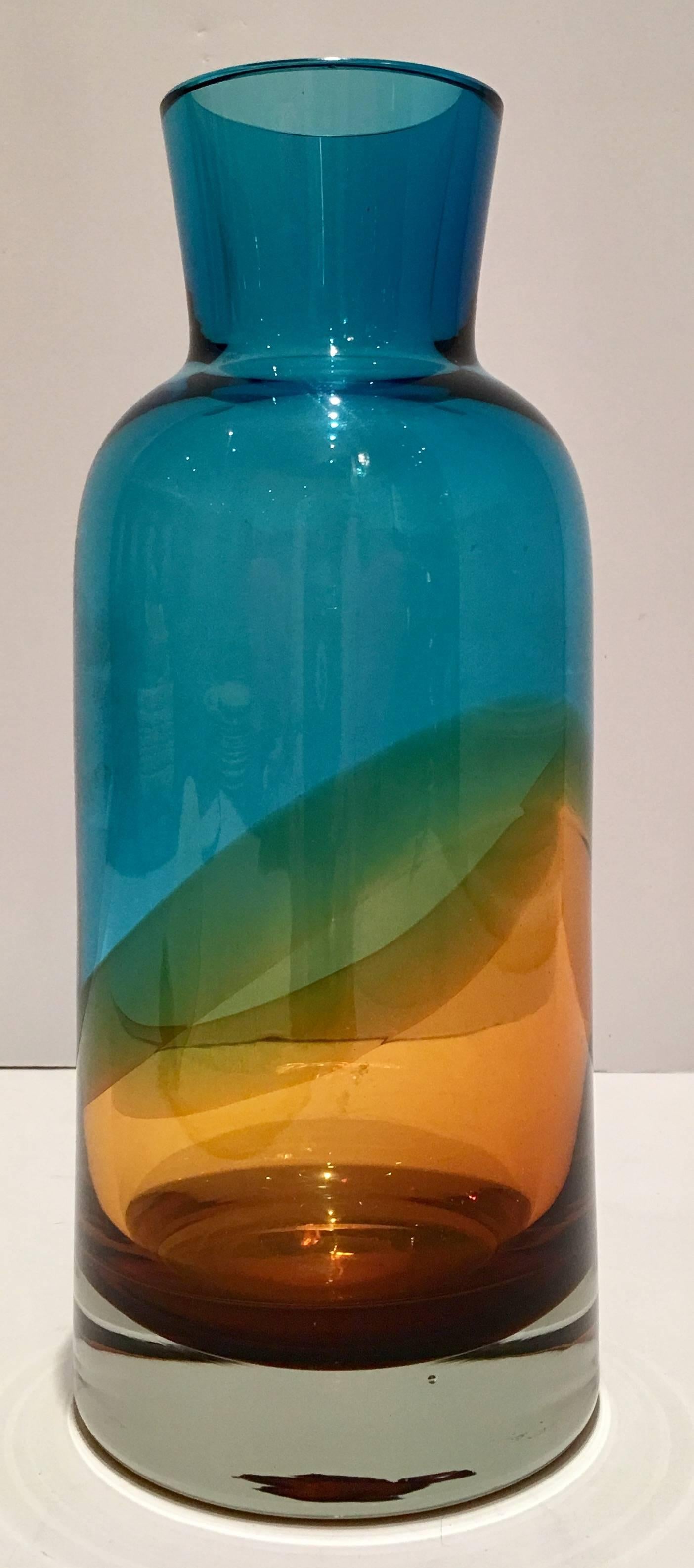 21st century Waterford Evolution collection turquoise and amber swirl bottle neck style vase. This vibrant vase is signed on the underside, Revolution Waterford. Top opening measures, 2.75" inches.