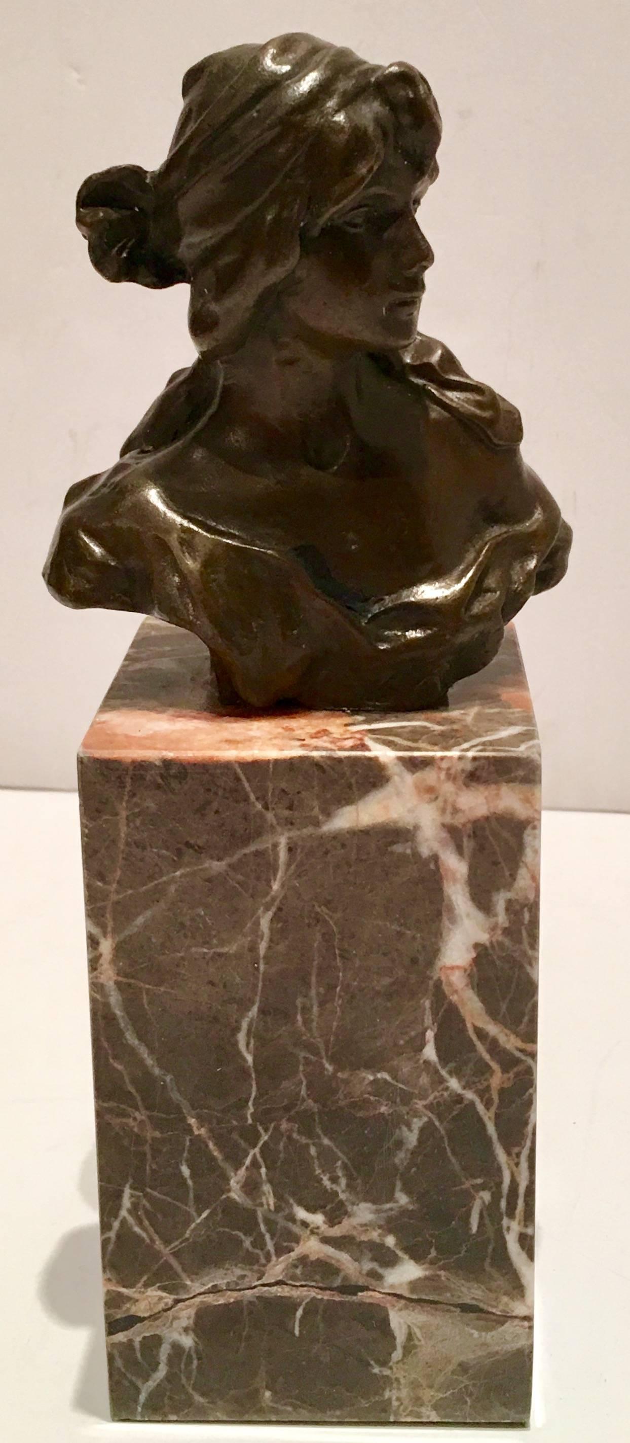 French Art Nouveau style female bronze bust on marble stand signed, Milo. Bust measures. 4.25" H x 4" L x 1.75" depth.