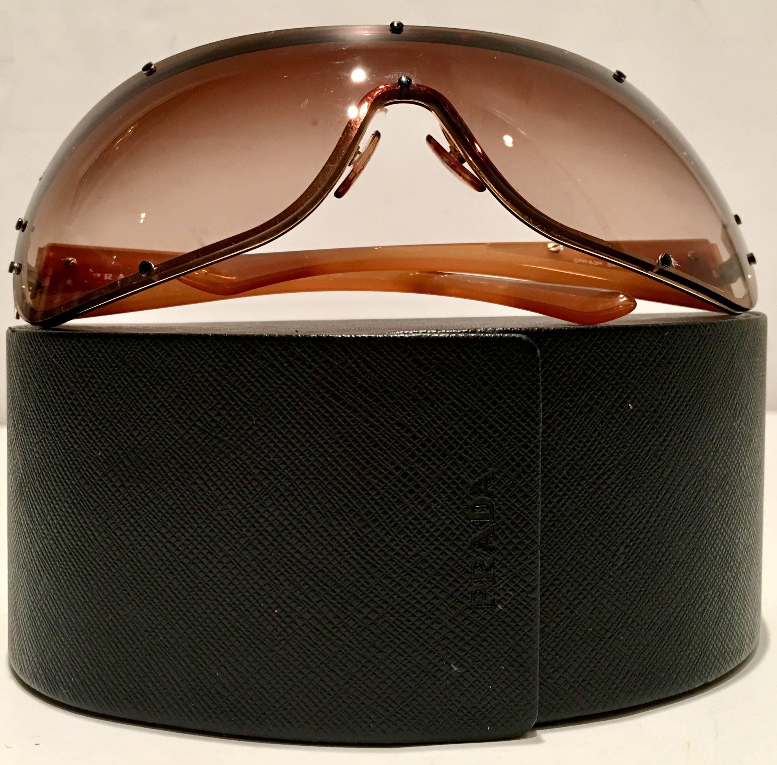 Rare Prada sport gold, butterscotch frame and brown gradient lens shield style sunglasses. Model 63H, Unisex. Includes a black folding Prada protective storage case. Signed on interior of frame, Prada made in Italy.