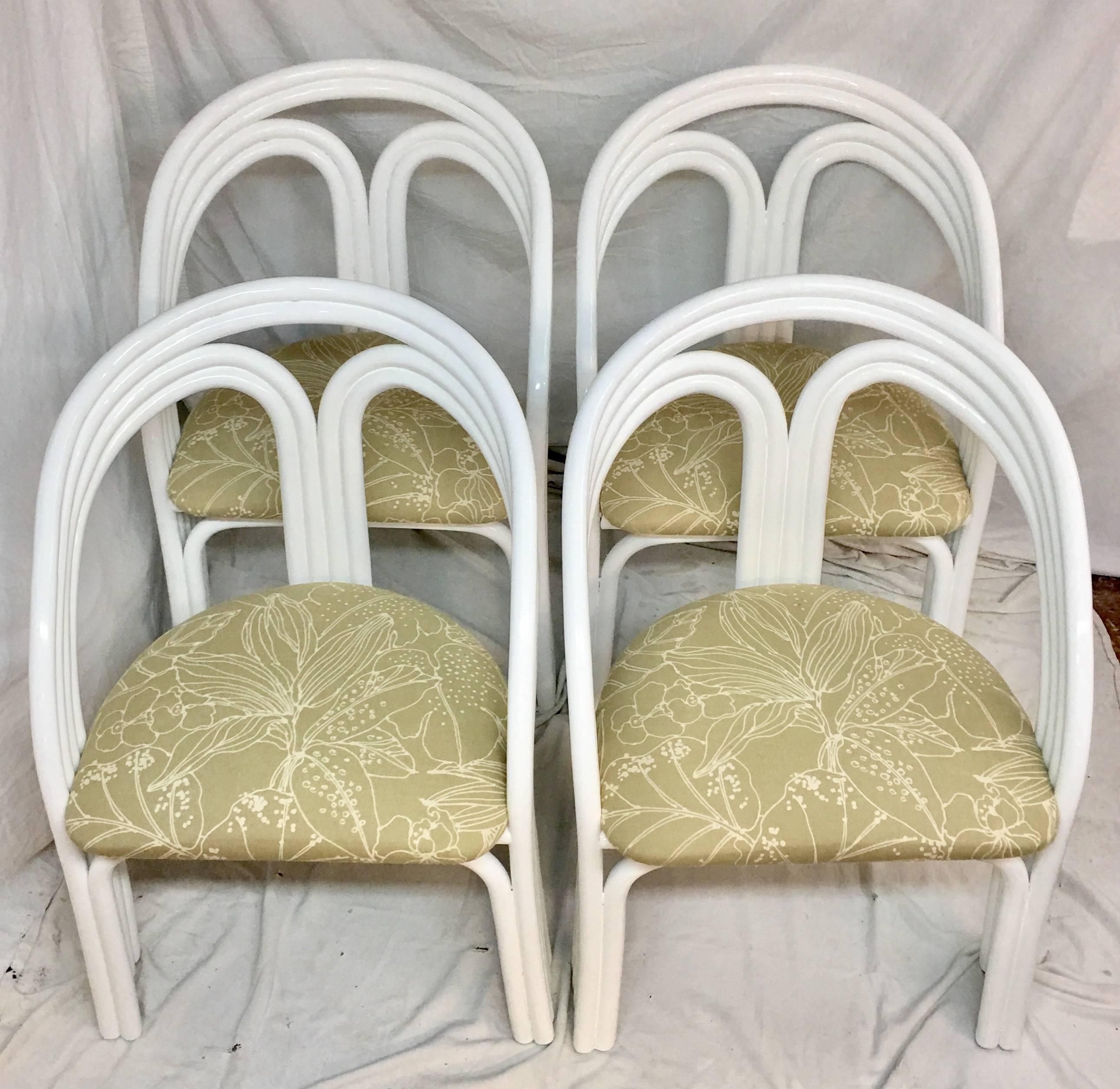 Mid-Century Art Deco set of four rattan reed upholstered chairs. Newly lacquered in white high gloss paint with khaki and white fern print cotton blend fabric.
Chairs are missing the manufacturing tag, most likely made by, Ficks Reed.