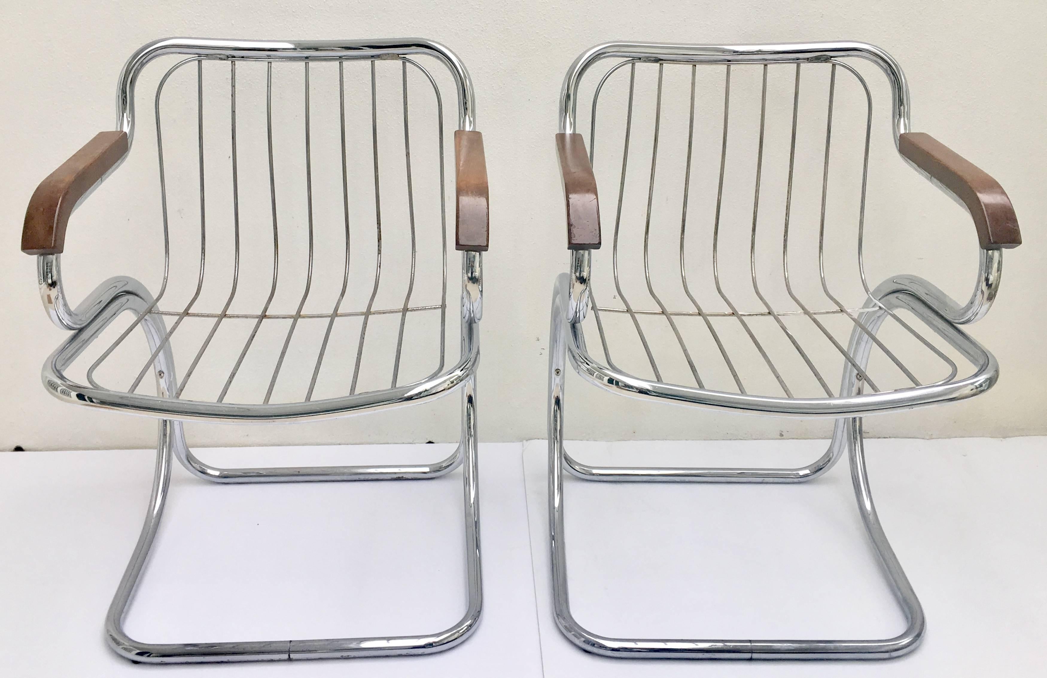 Pair of Mid-Century Modern Italian chrome and wood armchairs in the style of Gastone Rinaldi. Chairs are chrome wire cantilever in shape with wire back and seat and thick bentwood arm rests.