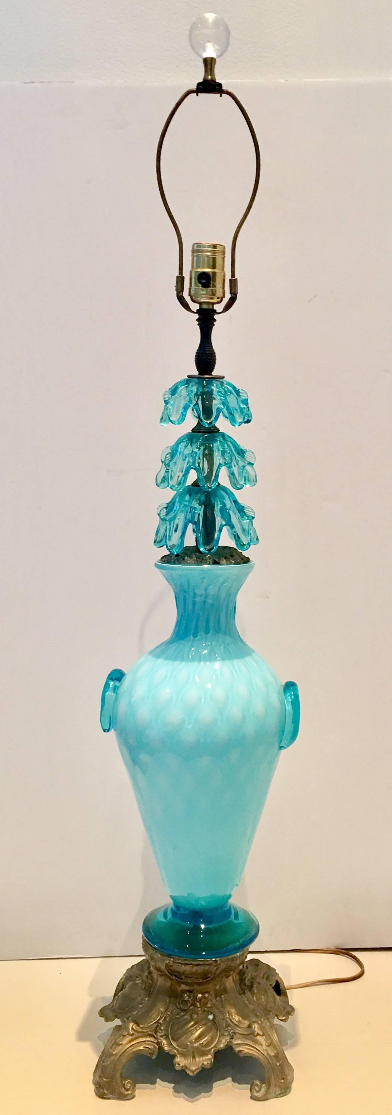 Mid-Century custom-made Murano glass lamp in robins egg blue and white. Features an applied two handle urn style vase body with applied ribbon detail at the neck. The body of the vase is opaline and quilted. The base and neck mounts are bronze.