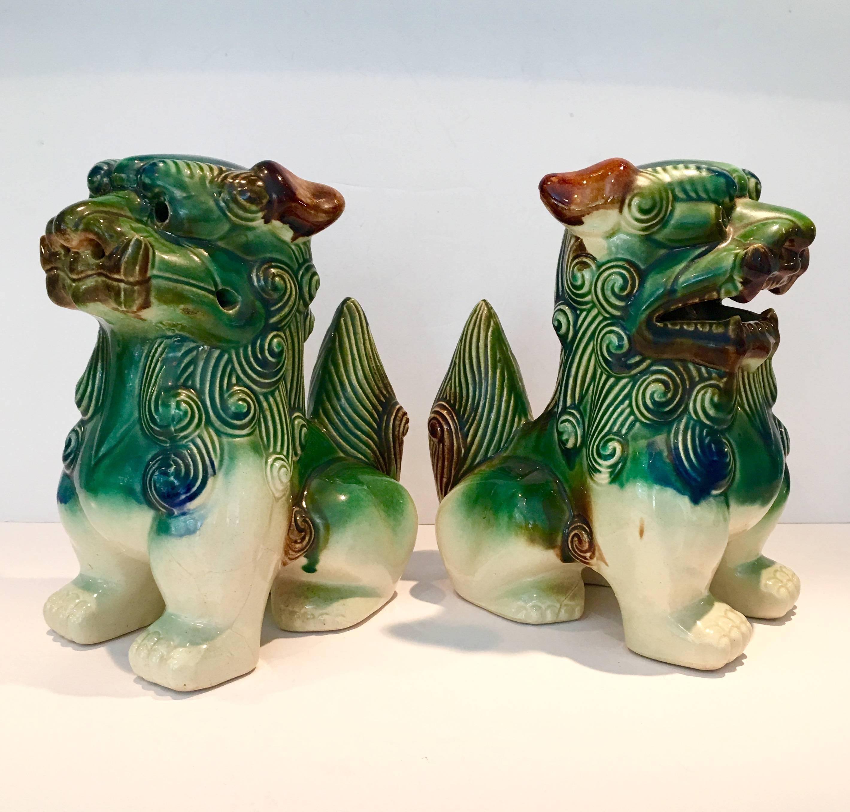 Vintage pair of Chinese ceramic glaze polychrome foo dogs.
       