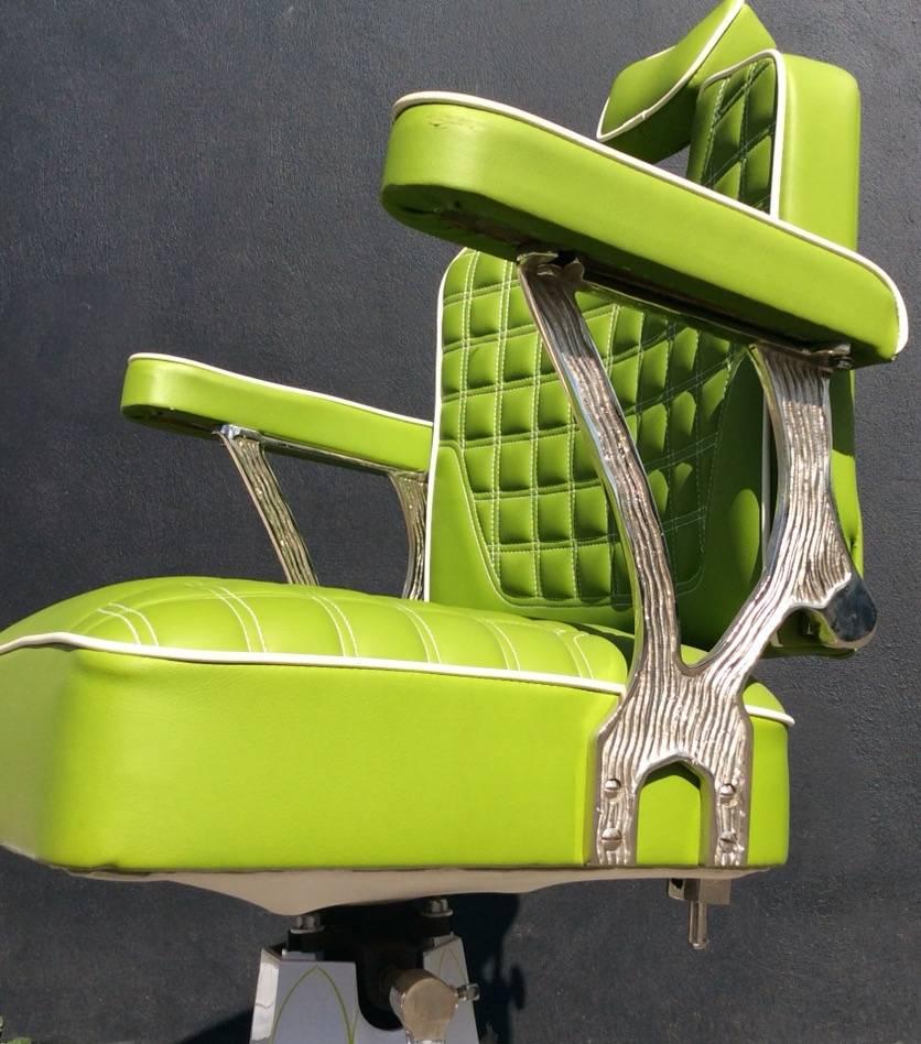 Customized 1960s adjustable barbers chair. Pin striped over pearl candy base with re-upholstered chair in green with cream piping.