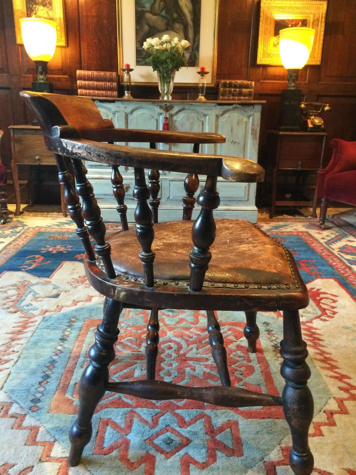 Antique 19th century Victorian solid oak smokers bow armchair or desk chair, arched back and standing on turned legs with H-stretchers, brown leather studded seat, with the most gorgeous patina, extremely comfortable.