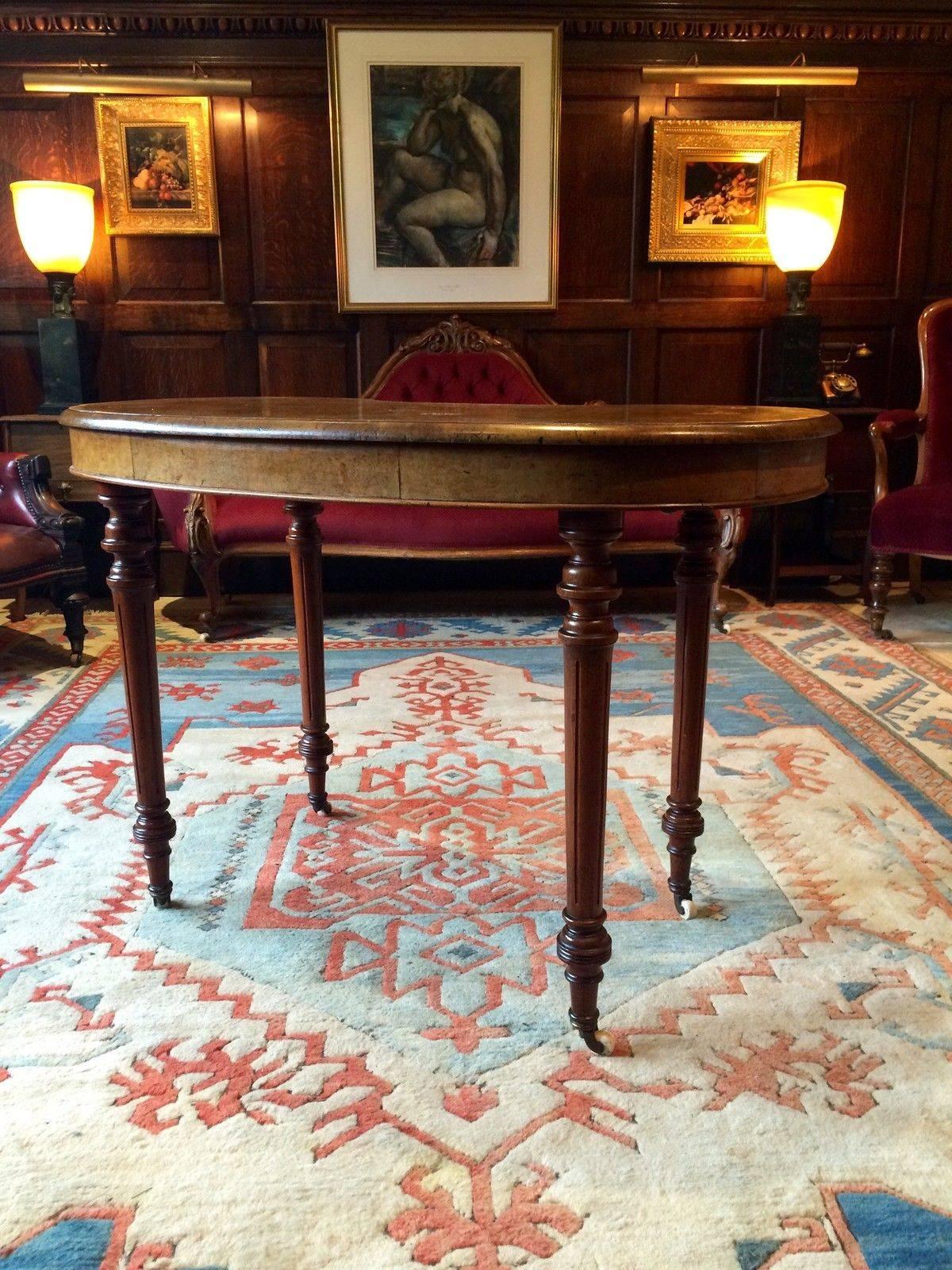 Antique Edwardian walnut kidney shaped writing desk standing on four turned legs all with original porcelain casters.