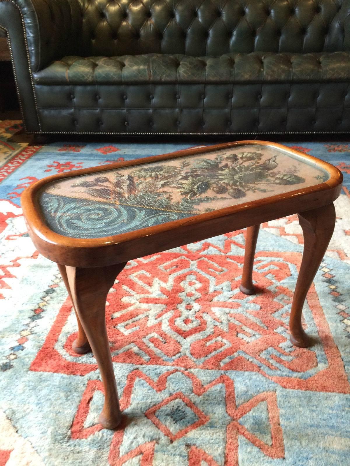 A small antique 19th century Victorian mahogany coffee table, rectangular glazed top with beadwork of flowers and scrolls, standing on four cabriole legs with pad feet.