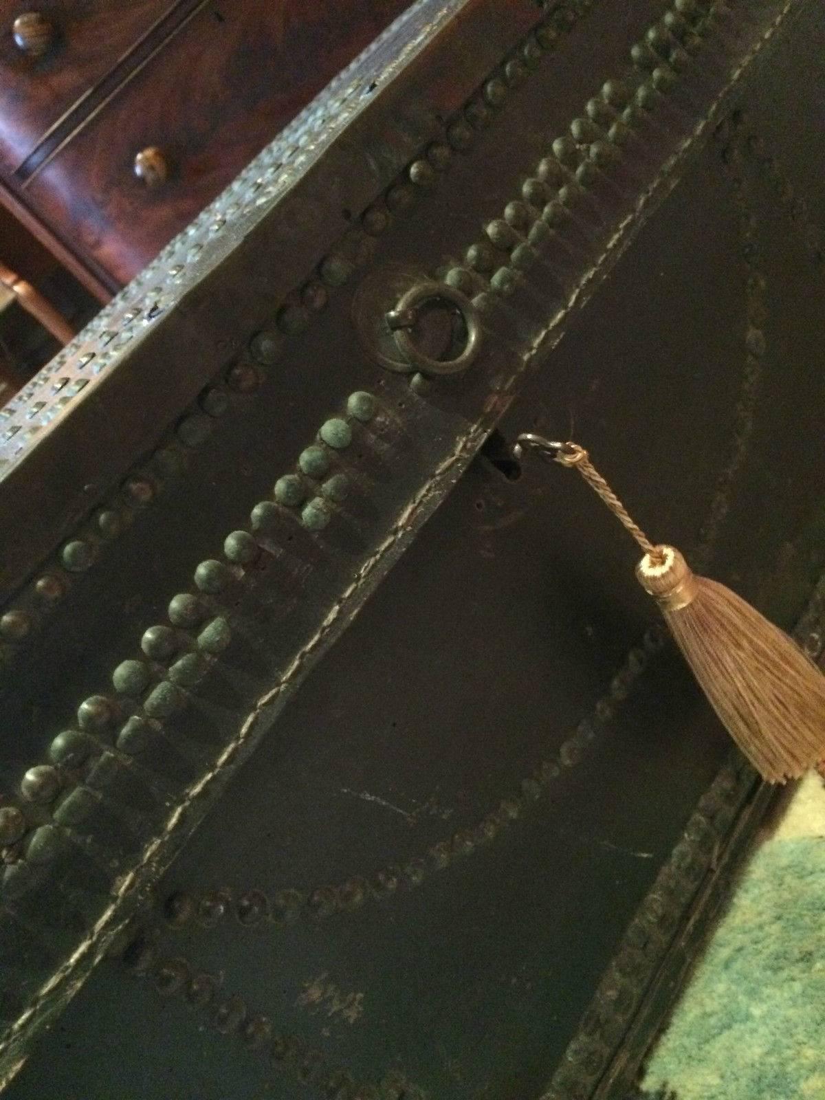 A gorgeous antique 19th century travel trunk chest, leather bound with brass stud work all over, brass drop carry handles to either side, can be used for travel, storage or as a coffee table, comes with key and tassel.