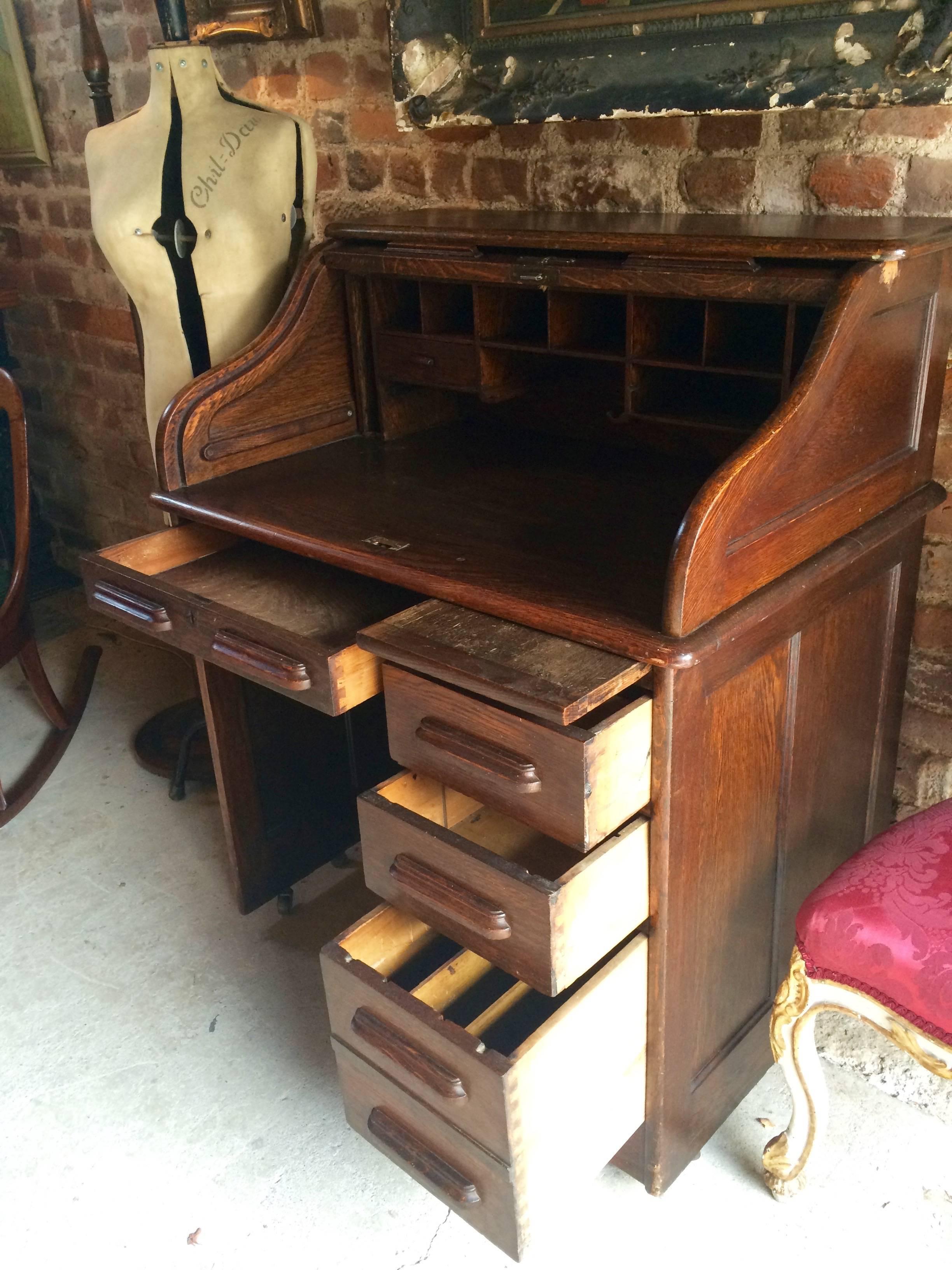 A large Edwardian solid oak roll top desk, with one small drawer and various pigeon holes to the writing area, the desk having a frieze drawer and three drawers to the right, a great investment for the future as well as a beautiful piece of