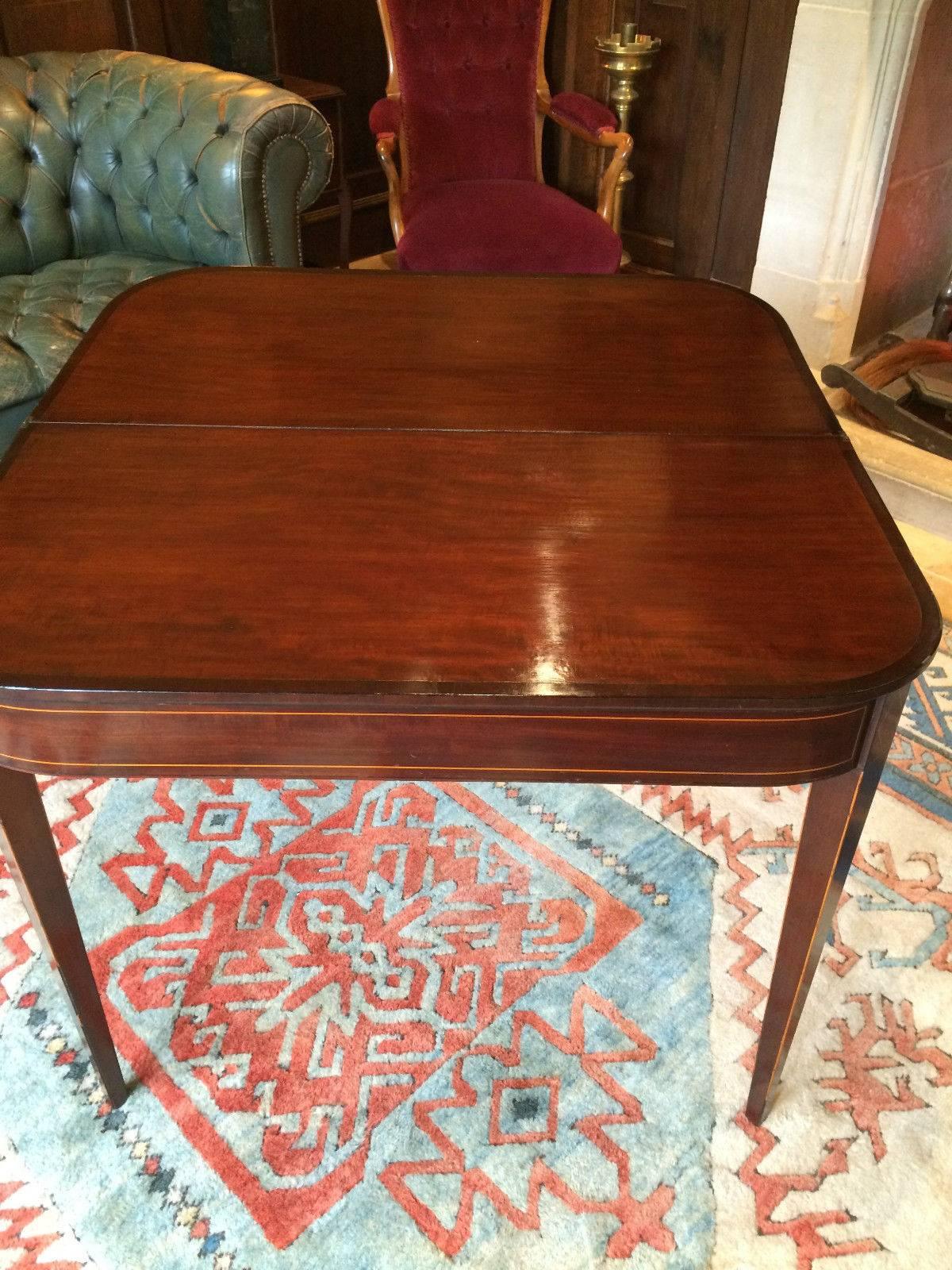 Antique 19th century Georgian mahogany D-shaped card games table with inlaid frieze on square tapering legs with spade feet.