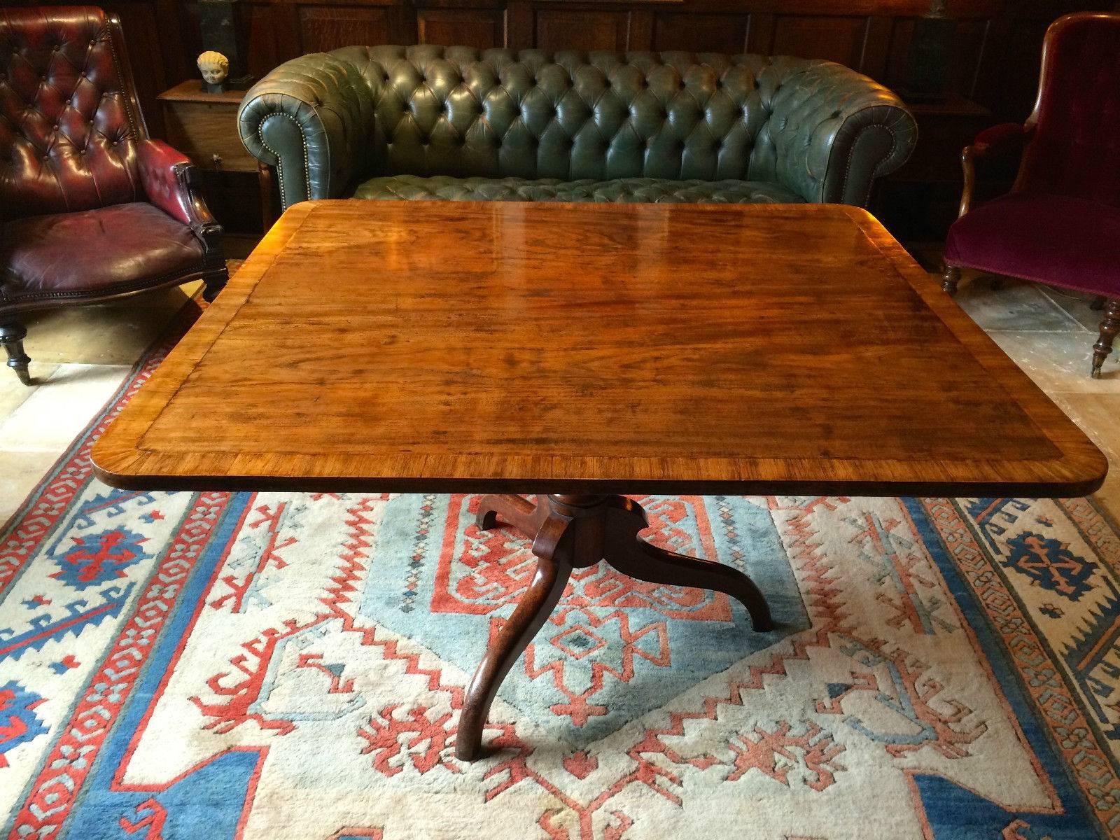 Antique Victorian mahogany dining table, circa 1840, the one-piece rectangular cross banded tilt-top, on vase turned center column and three splayed legs, beautifully aged with glorious patina.