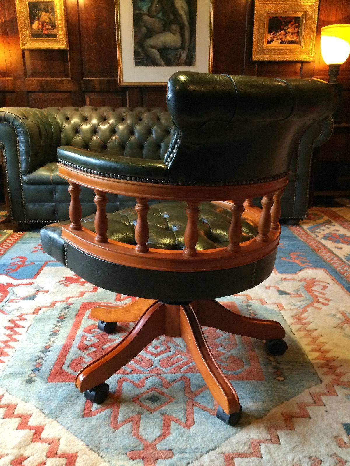 Gorgeous antique style reclining and revolving Chesterfield 'Captains Chair’ leather button-back bottle green leather, with overstuffed back and arms, spindle railed back and overstuffed seat, raised on four turned legs terminating in caster.