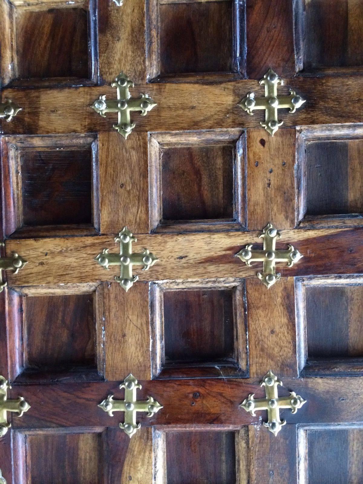 A stunning large Arabic brass studded wardrobe - armoire, this quality wardrobe with portcullis effect full length doors with applied brass bandings / roundels, flared plinth and cornice with hanging pole set within, please note this is a solid and