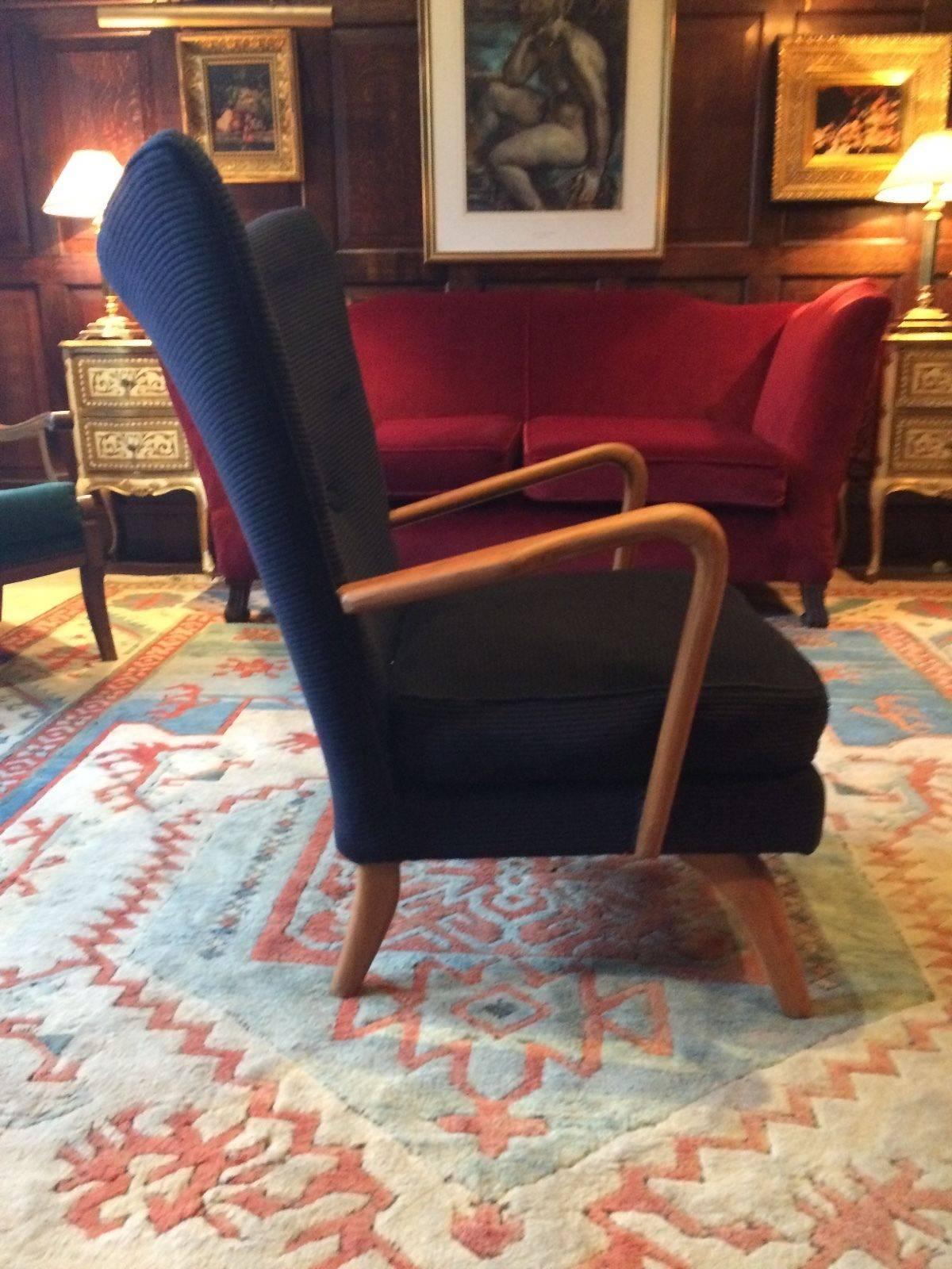A stunning and iconic Mid-Century early version of the stylish 'Bambino' armchair by the world renowned furniture designer Howard Keith, circa 1930s, the 'Bambino' chair is offered in original condition with dark navy blue corduroy upholstery, the