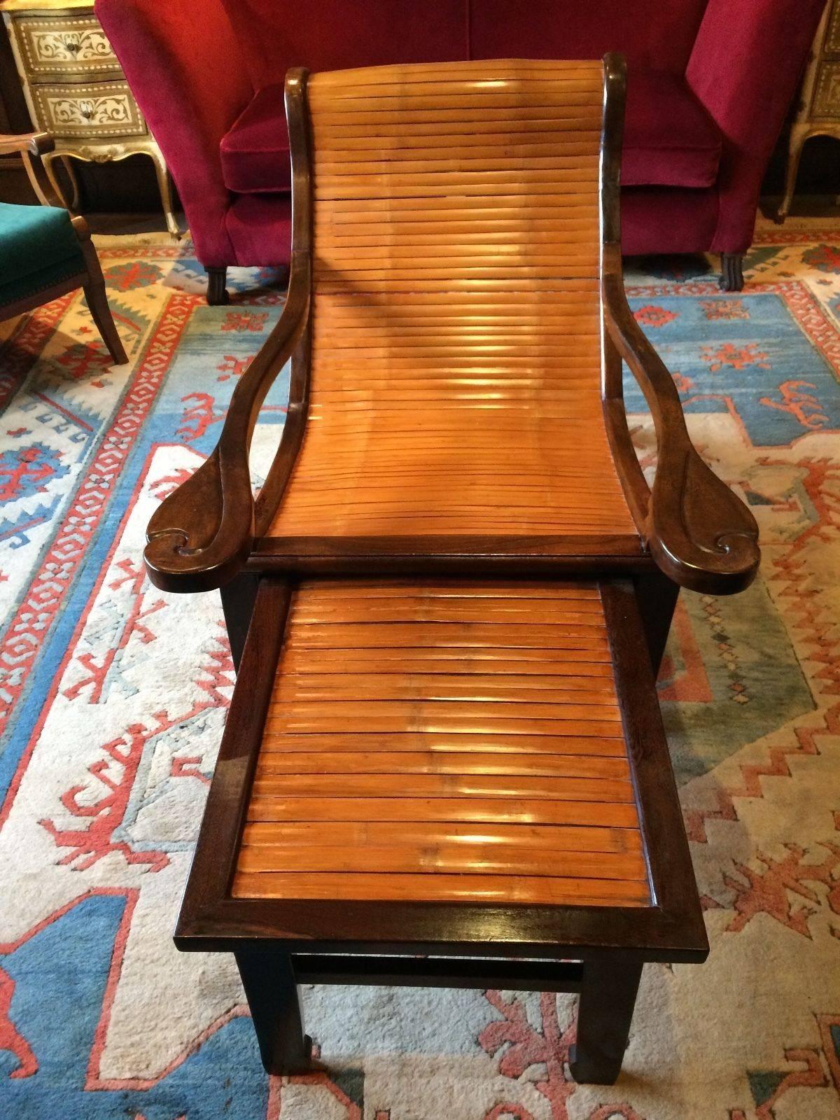 A beautiful Chinese jichimu and bamboo lounging chair, with long scroll ended arms, with pullout footrest.
