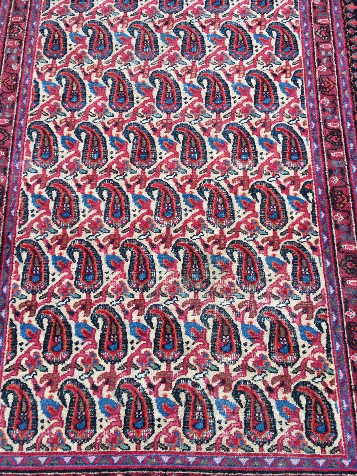 Gorgeous red and hook patterned wool Kashan rug. Measures: 5ft x 3ft.