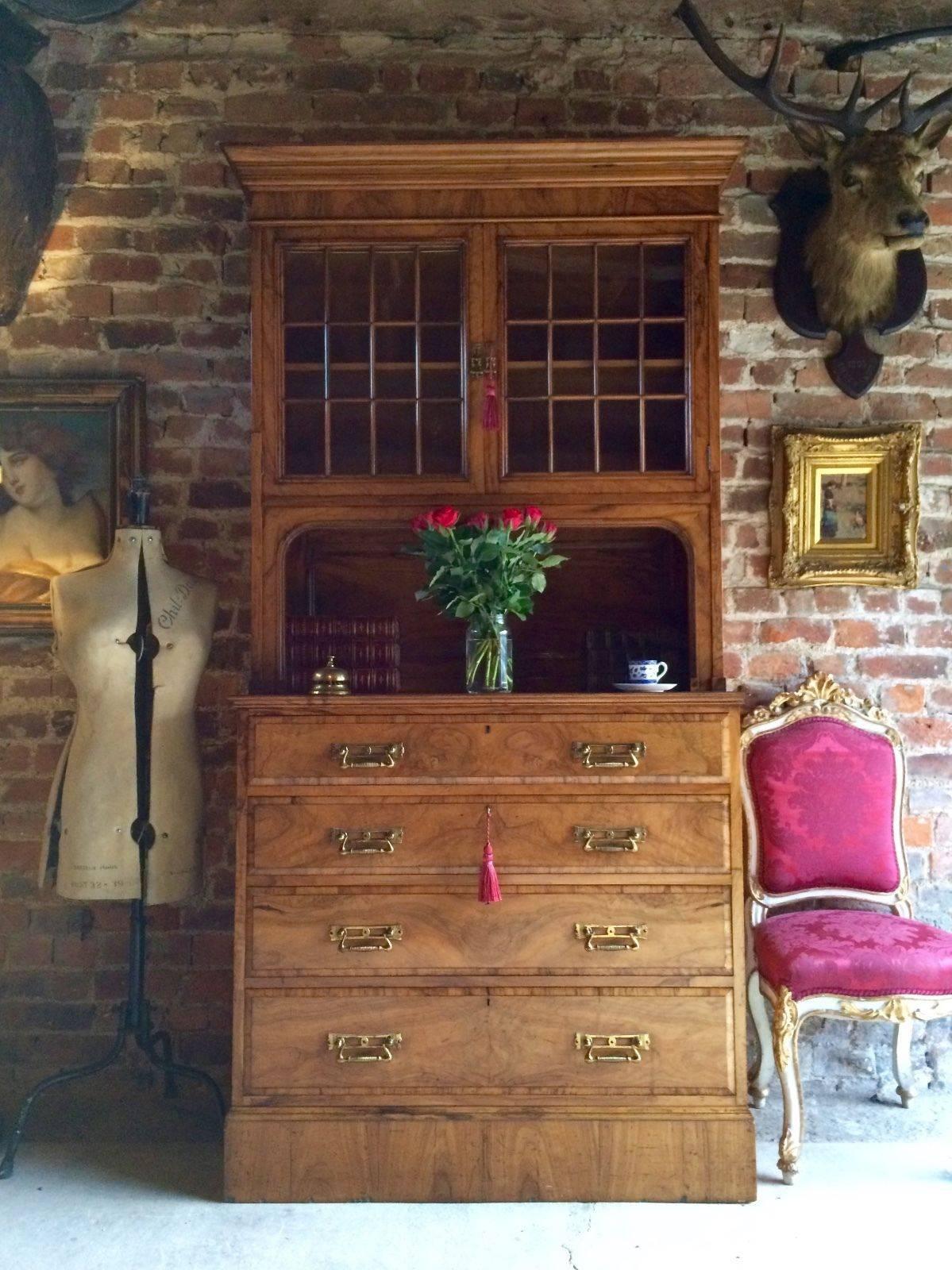 A stunningly beautiful, top quality Liberty & Co, London, late Victorian olive-wood tall cabinet over chest, circa 1875, the upper section with shaped and moulded cornice above a pair of glazed eighteen panel doors (single shelf within) an elegant