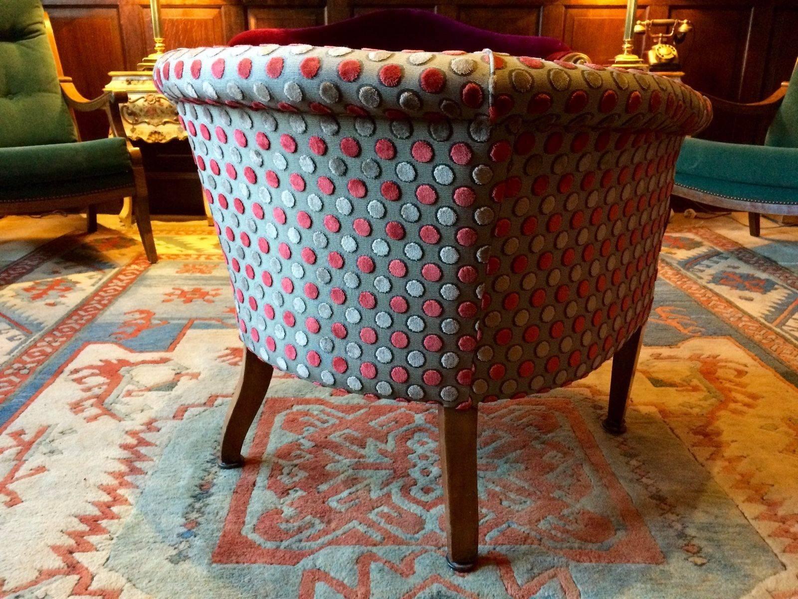 A fabulous Liberty style petit Victorian inlaid Mahogany upholstered tub-shaped club or cocktail armchair, circa 1890, the low show-wood front with circular fan petrae, upholstered in a wonderful 