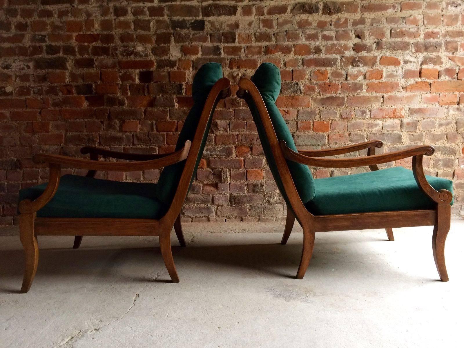 A stunning pair of recently reupholstered continental beech armchairs, late 19th century circa 1895, with fabulous down swept arm rests, on low sabre legs, with lush green button backed velvet style upholstery, extremely comfortable and offered in