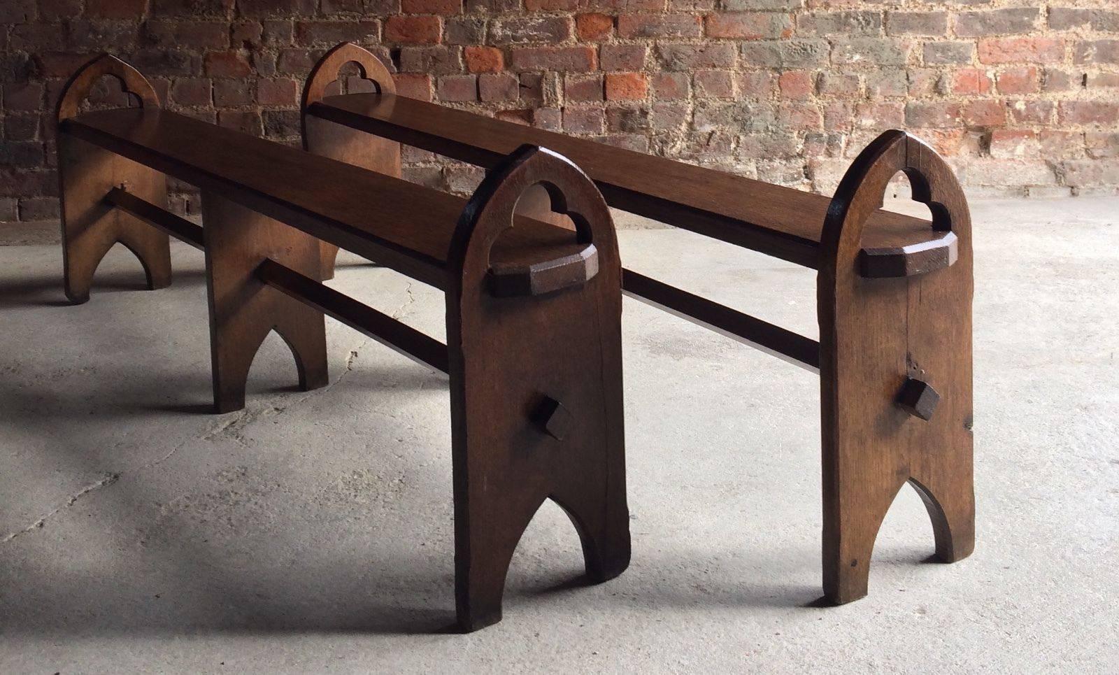 A truly magnificent Victorian pair of Pugin style Gothic solid oak bench seats, circa 1870 with pierced arch end standards and central stretcher, wonderful aged patina to the oak and offered in excellent condition.