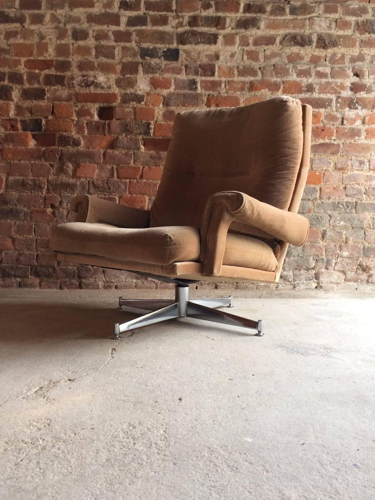 An original 1970s retro Mid-Century swivel armchair by Howard Keith for HK Furniture of London, raised on a chrome quadruple leg base with swivel action and having velour beige upholstery with HK label to underside, the chair is in its original