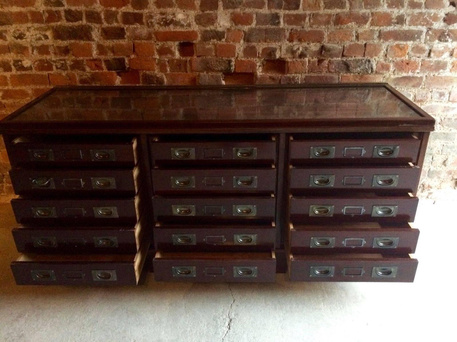 A beautiful early 20th century extremely large shop haberdashery solid mahogany 15 drawer shop counter with lift up glass top. There are three doors covering the drawers (these have been removed and can be reattached if needed), large rectangular