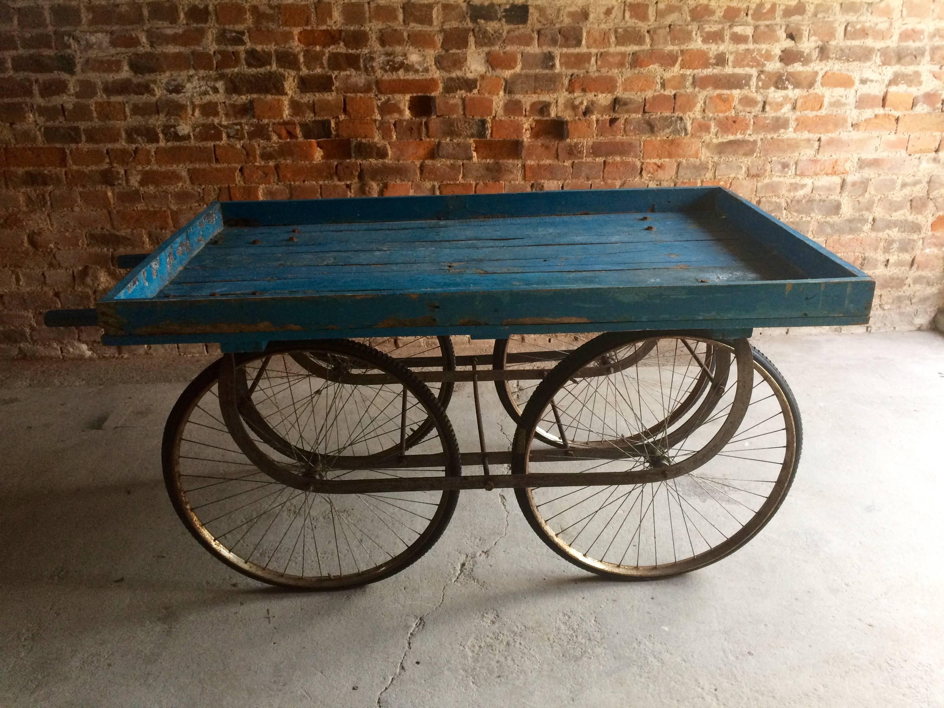 20th century Indian market cart

Description:

A stunningly beautiful antique 19th century Indian market hand cart, large bed over tall suspension frame with four bicycle tires, two short handles to push, the cart is finished in a deep blue which