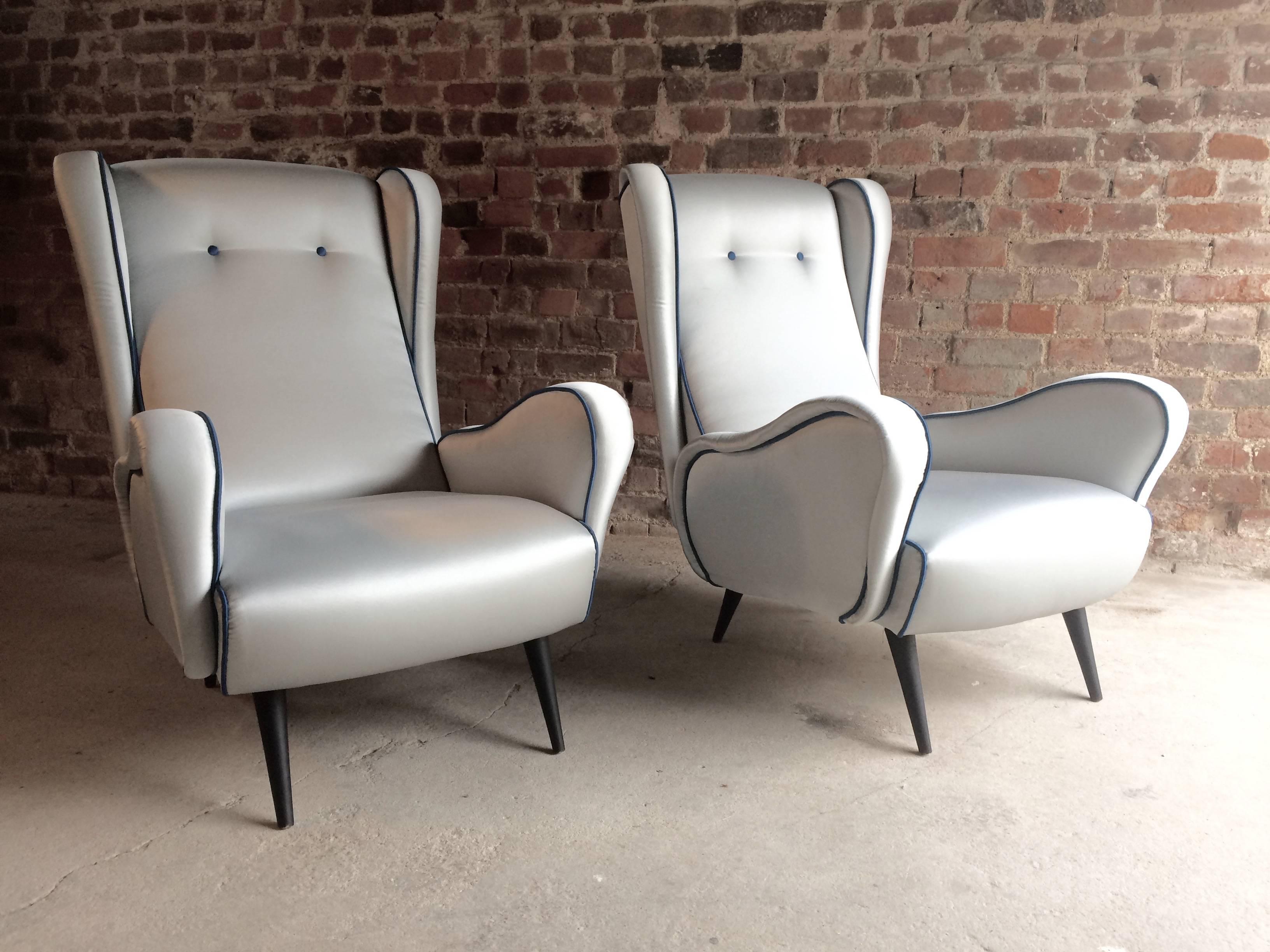 Stunning Mid-Century Italian design armchairs, 1950s

A fabulous original vintage pair of 1950s Italian armchairs, in blue, with electric blue piping, on black ebonised tapering wood legs, wonderful 1950s iconic design lines, looks amazing

Please