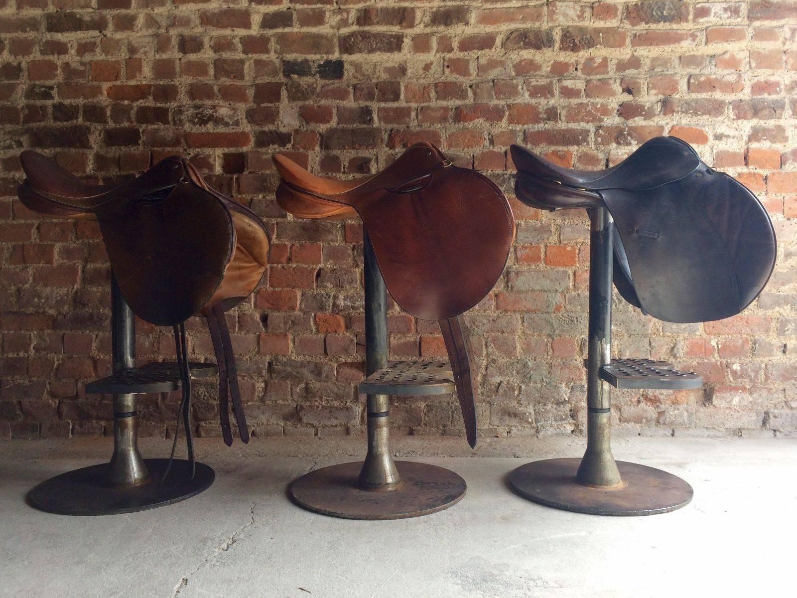 A beautiful set of three Industrial style leather and steel horse bar stools, each saddle is a slightly different shade of brown leather, extremely comfortable and very unique, look amazing!

Please note: I also have a fourth matching stool but