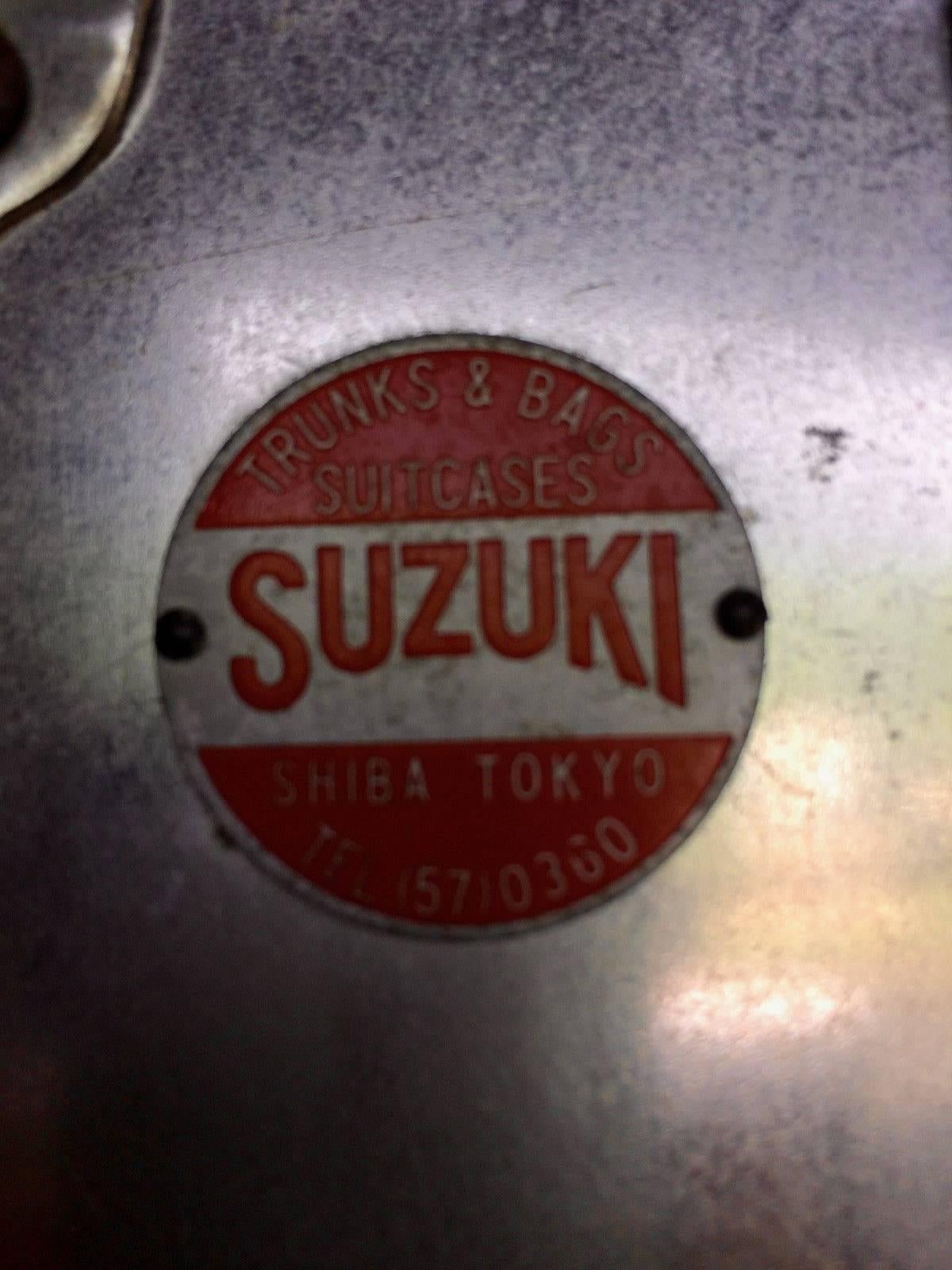 A stunning and original, extremely rare Mid-Century Japanese Suzuki, Shiba, Tokyo metal cased Industrial travel trunk, with studded outline and heavy locks, leather carry straps to both sides, riveted all-over, lined with a tray inside, looks