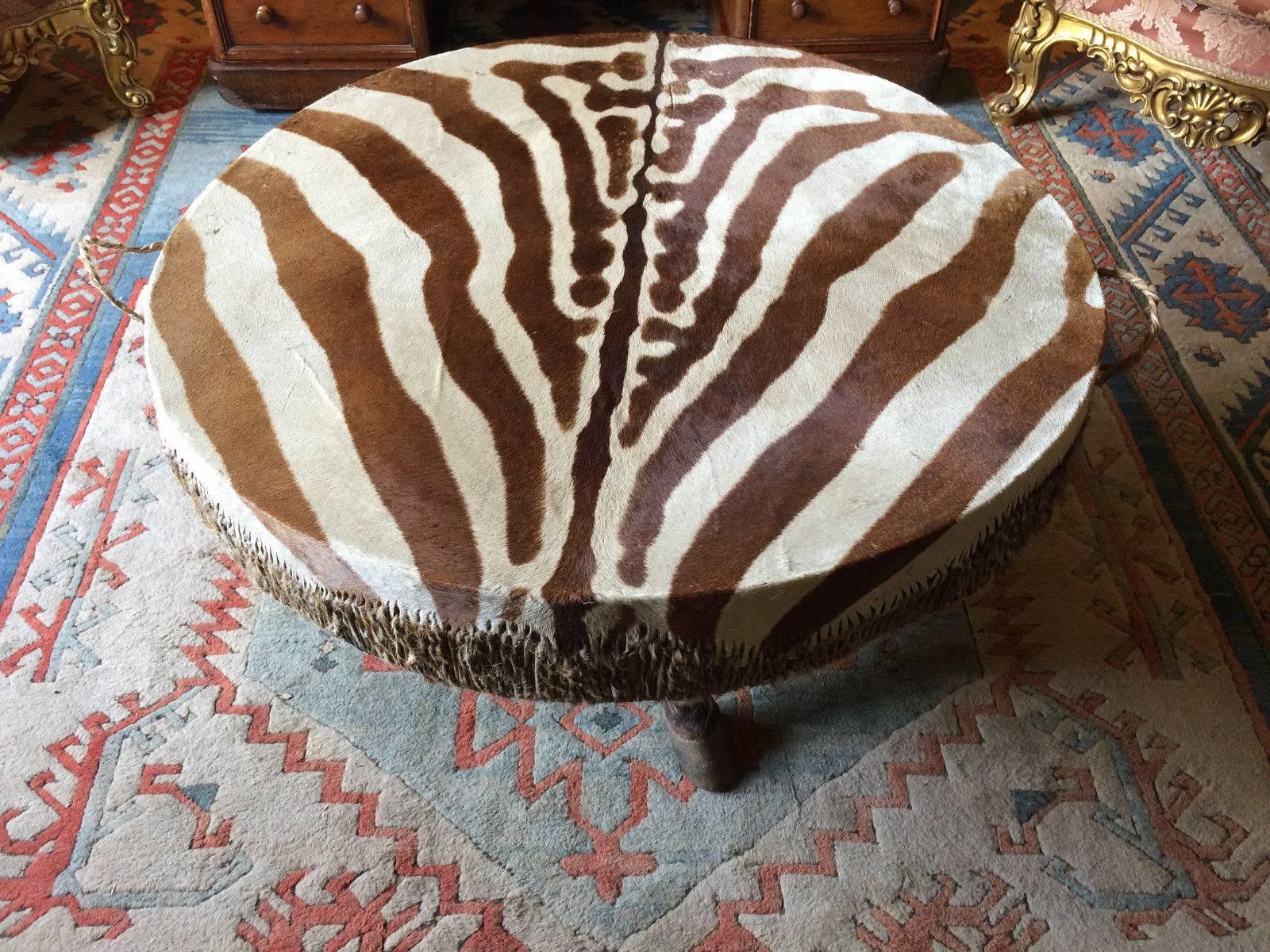 A stunning large antique African Zebra hide drum on hoof legs, the drum would make a unique coffee table by simply adding glass (we can arrange this for you) this really is a breathtakingly beautiful piece that will adorn any room, looks amazing.