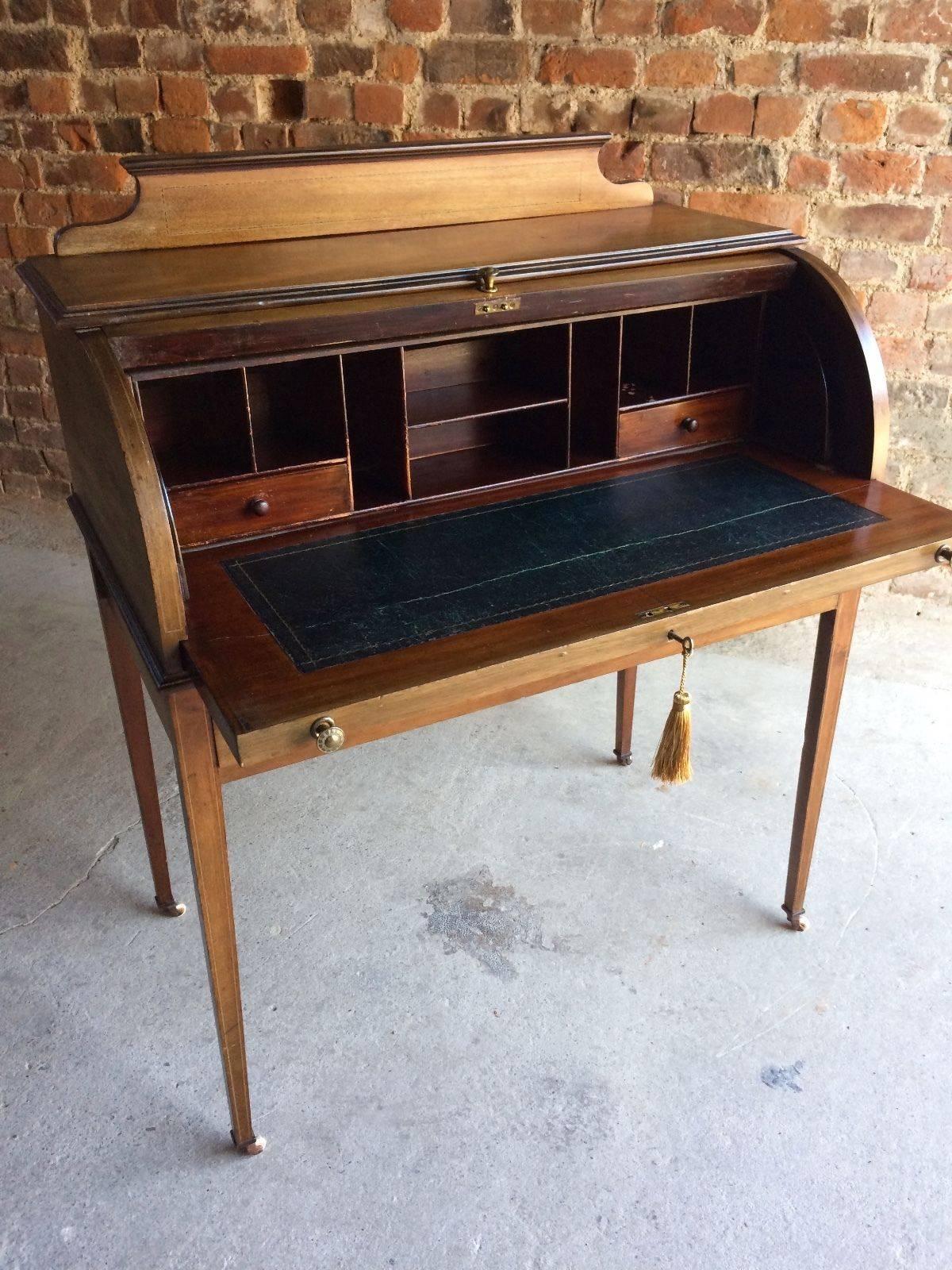 A stunningly beautiful Antique late 19th-early 20th century cylinder roll top bureau, the roll top enclosing various pigeon holes and two small drawers. The desk having slide out writing surface and two drawers below, raised on square tapering legs,