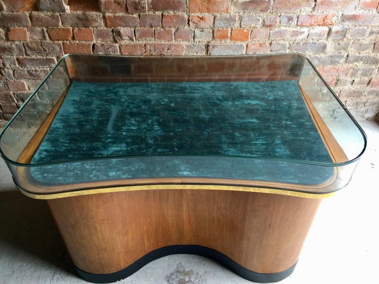 A beautiful pair of matching mid-20th century Haberdashery shop display cabinets, the shaped flat glazed top with brass surround and pull-out display drawer with turquoize baize, over two pedestal bases to the reverse with eighteen lined drawers,