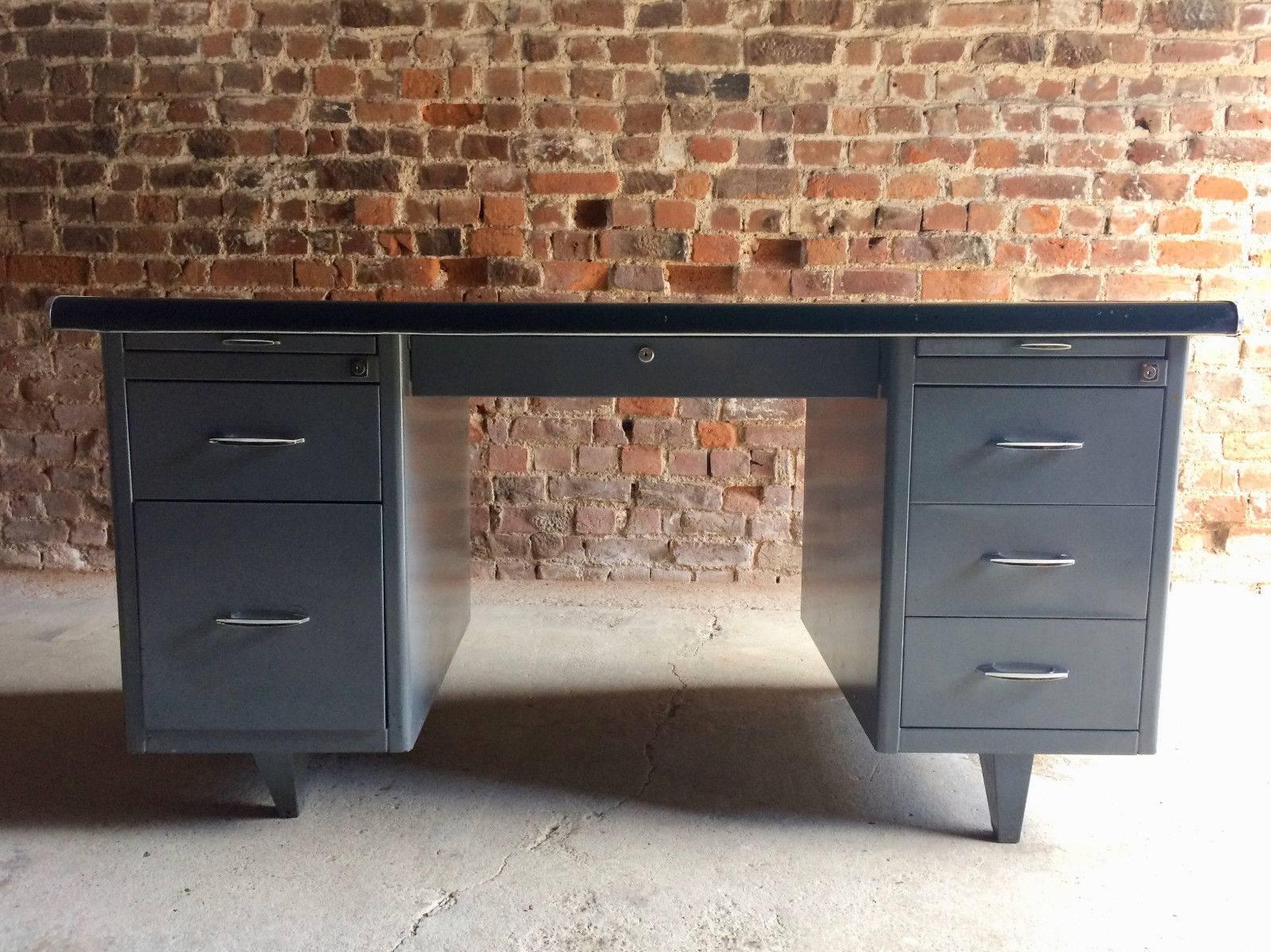 A stunning 'Statement Piece' vintage Industrial Mid-Century twin pedestal steel tanker desk, circa 1950s, the rectangular rounded green desk top over a central frieze drawer with two pedestals each with two brush slides and fitted with five drawers,