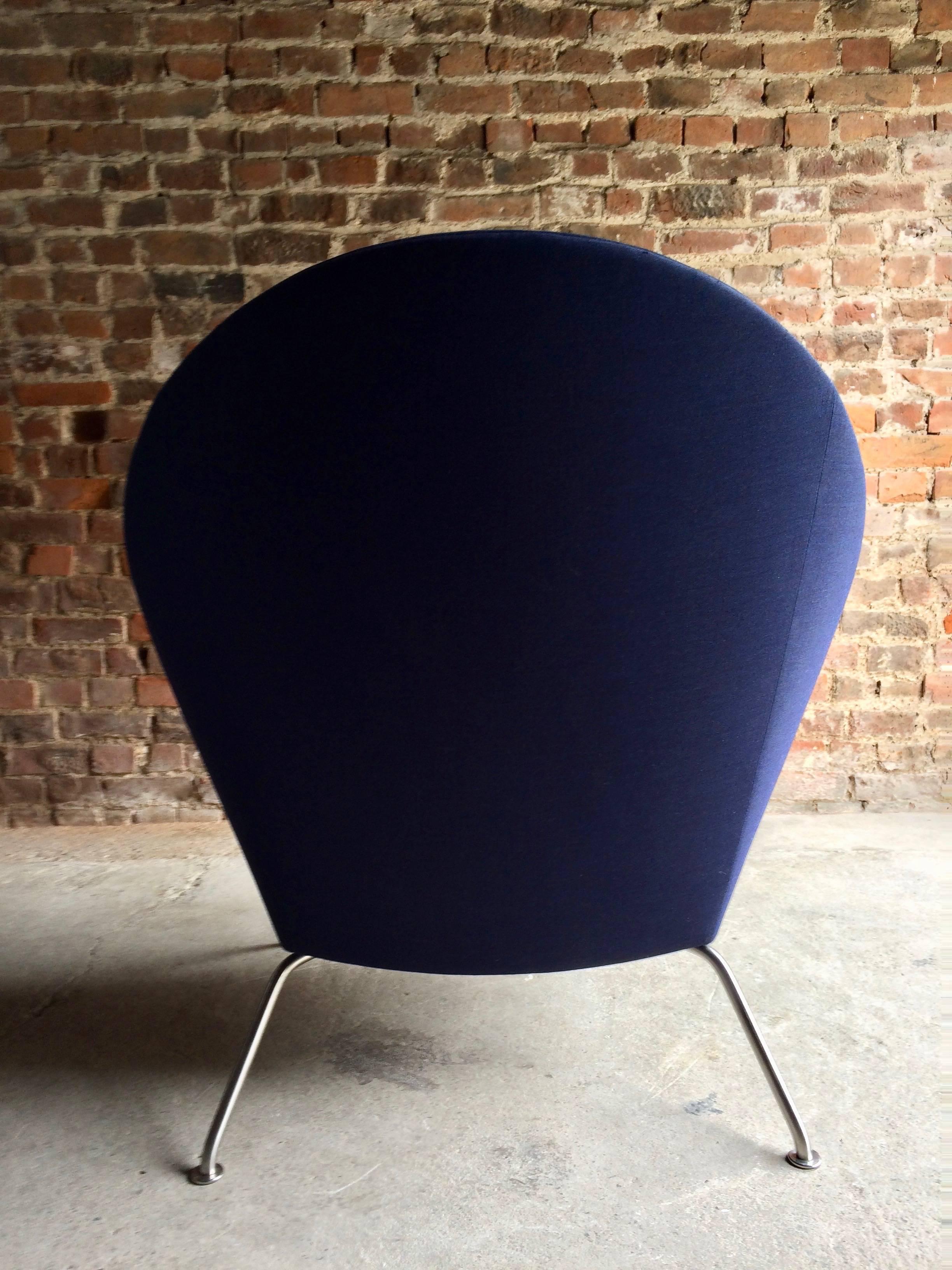 A model 468 oculus lounge chair, designed by Hans Wegner, manufactured by Carl Henson 2002, in blue fabric, on satin steel legs, bearing makers label to underside.

A sought-after and sculptural armchair designed by Hans J. Wegner in the 1960s,