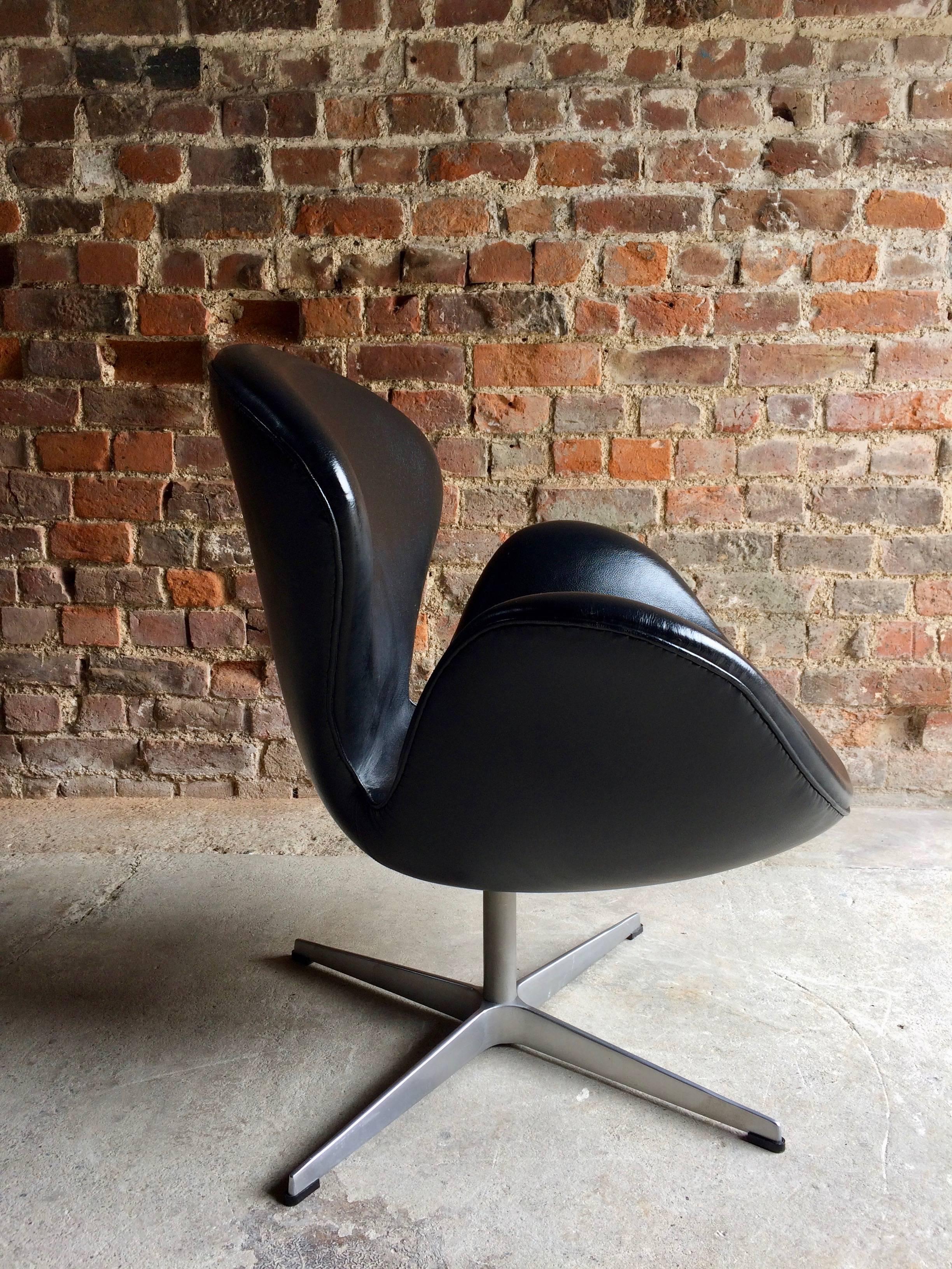 A Swan chair designed by Arne Jacobsen and manufactured by Fritz Hansen circa 2002, soft black leather hide with steel swivel base, makers label under seat, stamped under base.

Arne Jacobsen designed the Swan™ as well as the Egg™ for the lobby