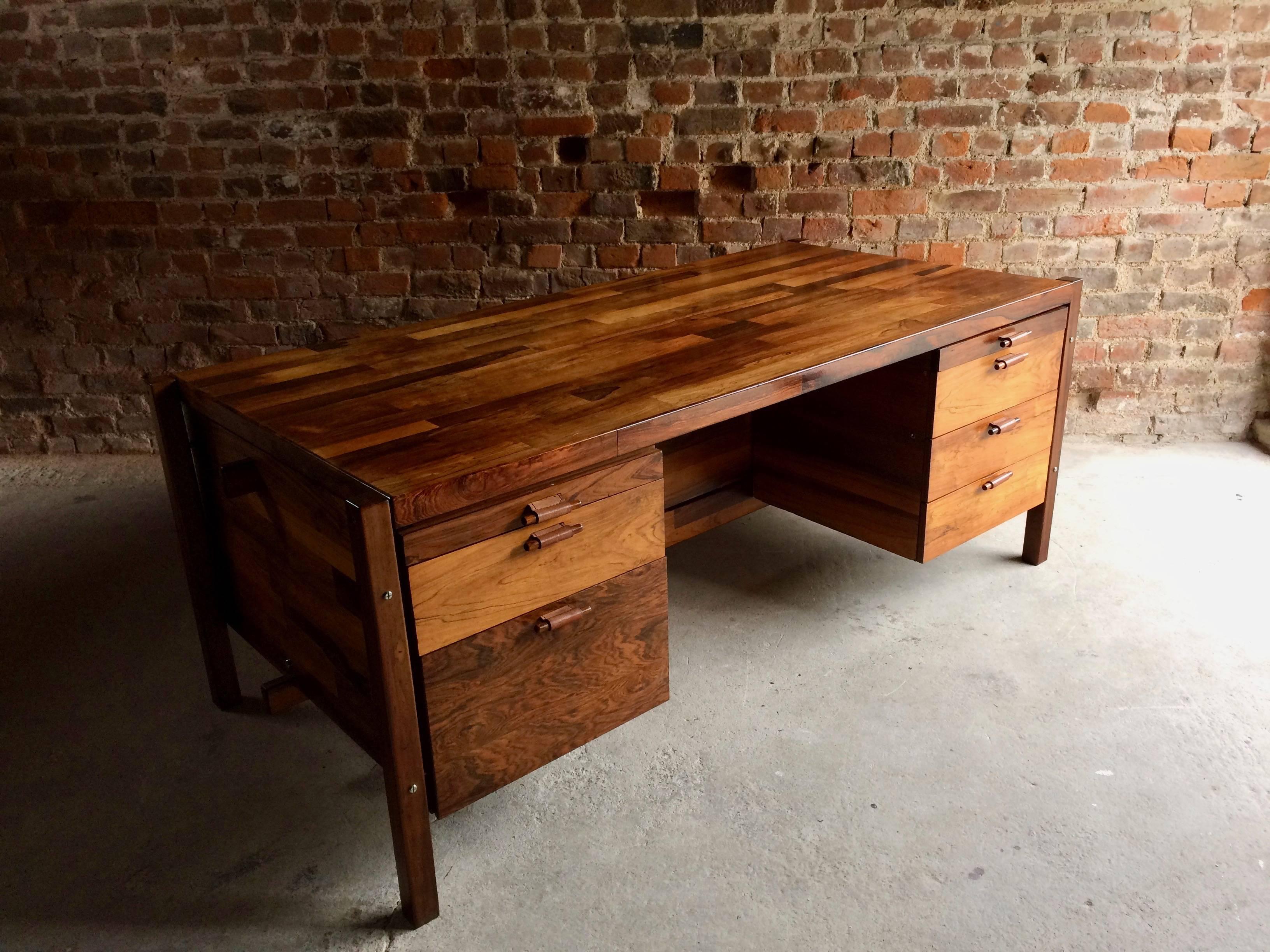 A rare and extremely beautiful Mid-Century 'Jacaranda' desk by Jorge Zalszupin produced by L’Atelier, circa 1960. This large Brazilian rosewood executive twin pedestal desk with typical patchwork design is fitted with a bank of seven graduating