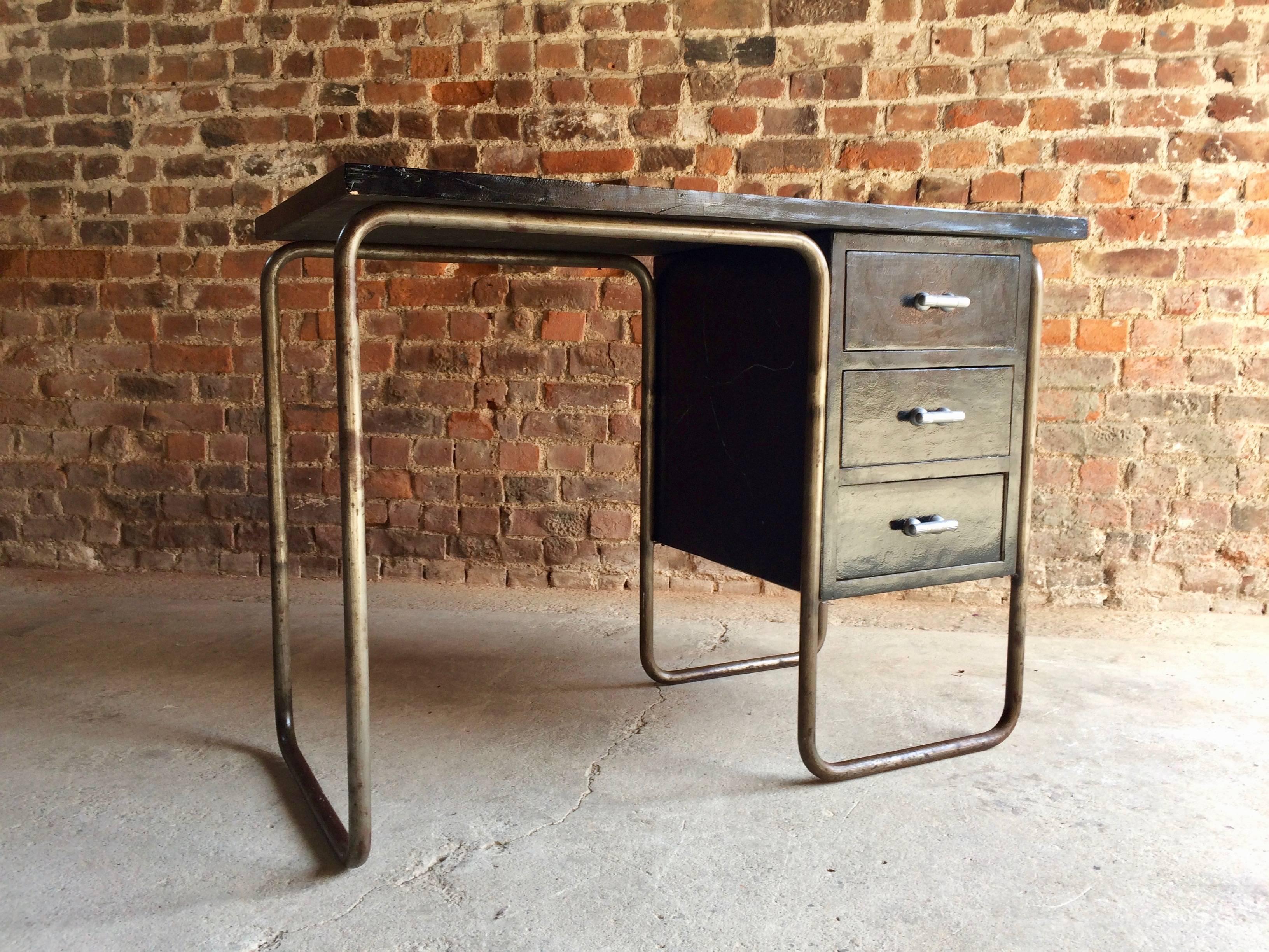 Early 20th century, vintage Thonet black painted and tubular steel desk, designed and dating to circa 1930s, with three drawers, the lightly distressed black wood work appears to have been refreshed overtime and the metal work is pitted and lacking