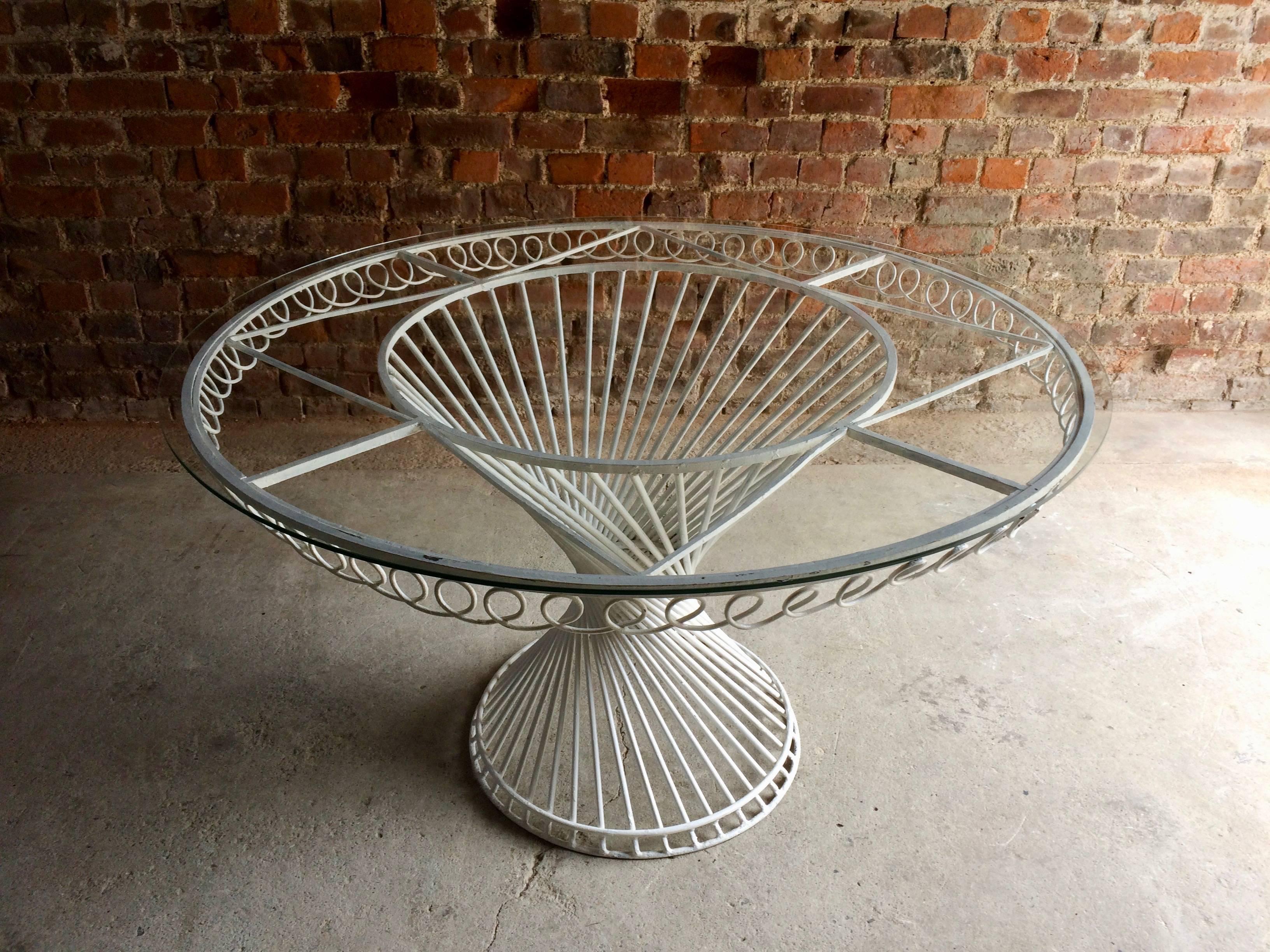 French Mathieu Mategot Antheor table, circa 1950s, with white painted steel rod construction and circular glass top, in good structural condition, repainted at some point and paint is flecking in places, glass has one small chip to edge barely