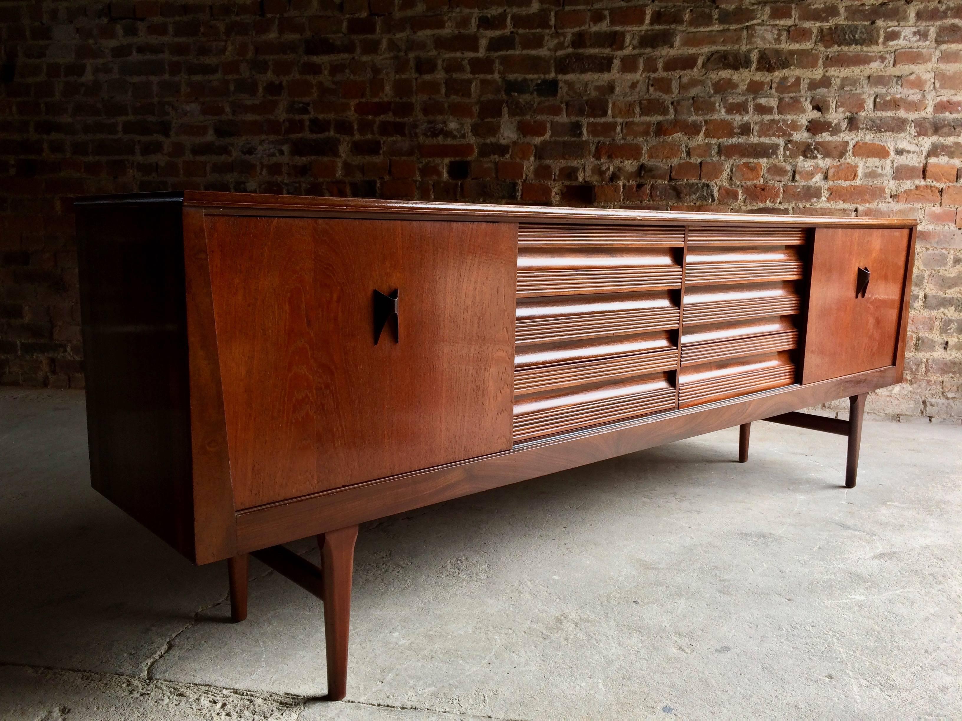 EON (Elliotts of Newbury) teak sideboard credenza circa 1970s, this fabulous Danish inspired teak sideboard with its triple sliding door cabinets features ample storage space with a central bank of three drawers with ribbed detailing to the fronts,