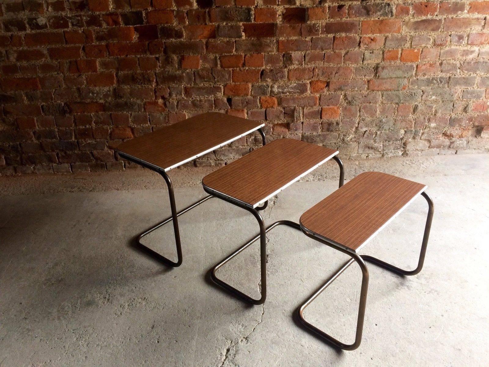 A stunningly beautiful trio nest of counter lever nesting tables of tubular metal construction being Formica topped in the manner of 'Tavo'. Offtered in great vintage condition, the tables stack together making them ideal for smaller spaces, looks