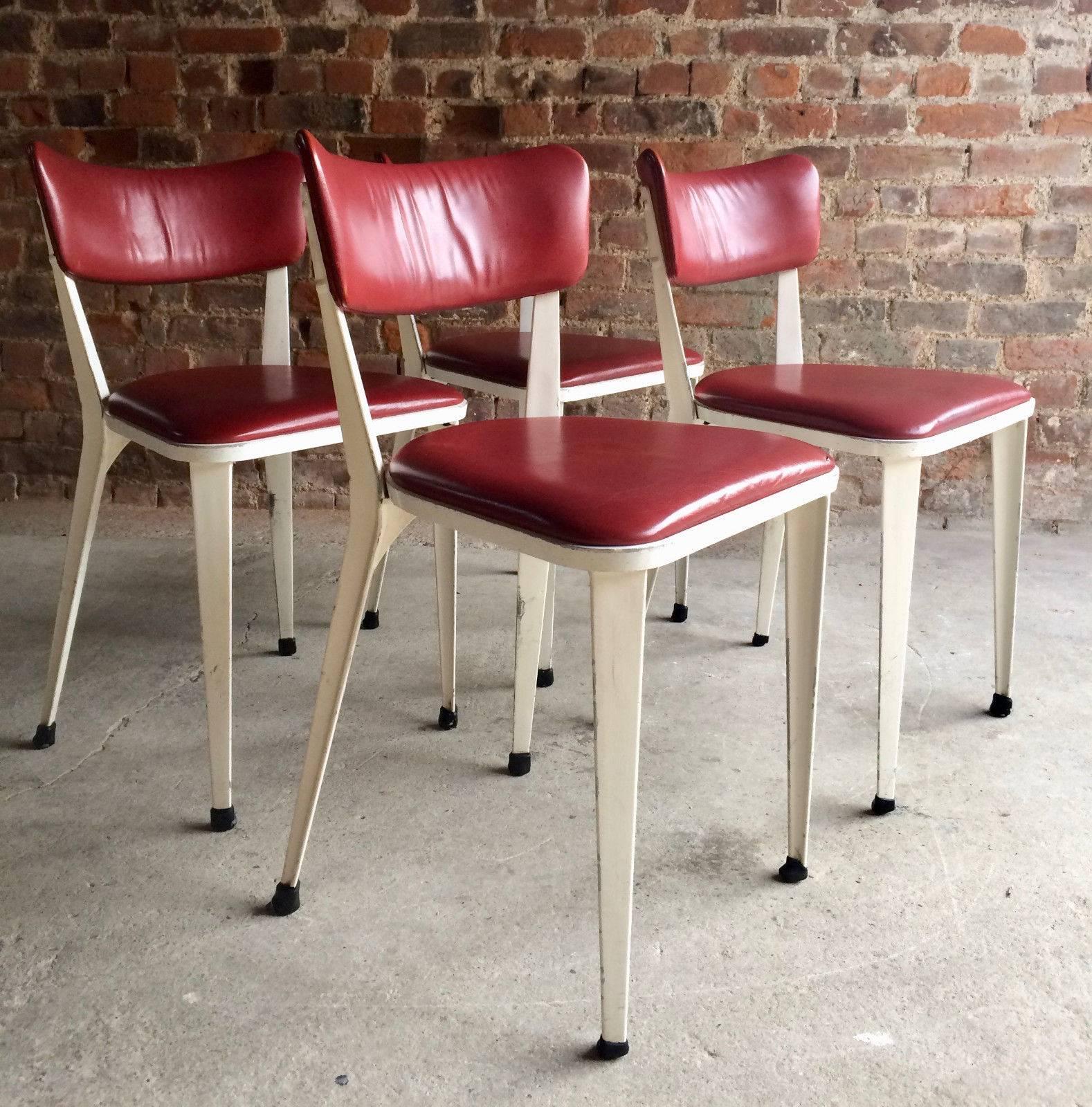 A fabulous set of four original 1950s Ernest Race BA3 aluminium chairs finished in white with cherry red leather upholstery, the chairs do have a patina showing age marks and scuffs adding to the overall charm and beauty of the set, there is a tiny