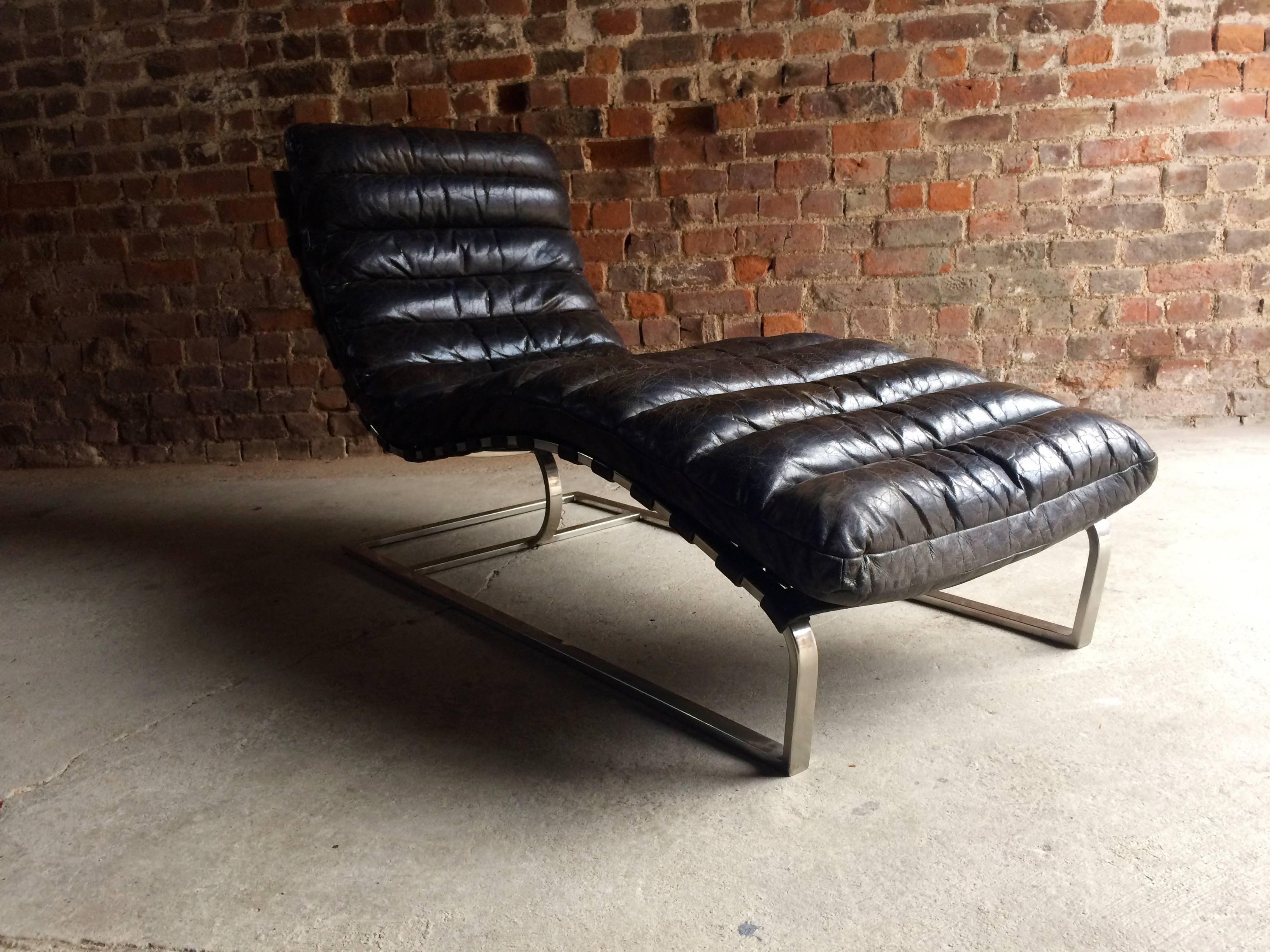 A stunningly beautiful vintage Mid Century contemporary leather Italian chromed steel chaise lounge day-bed. The Chaise having thick black one-pice channel-stitched leather wrapped cushion and standing on cantilevered base crafted of sleek