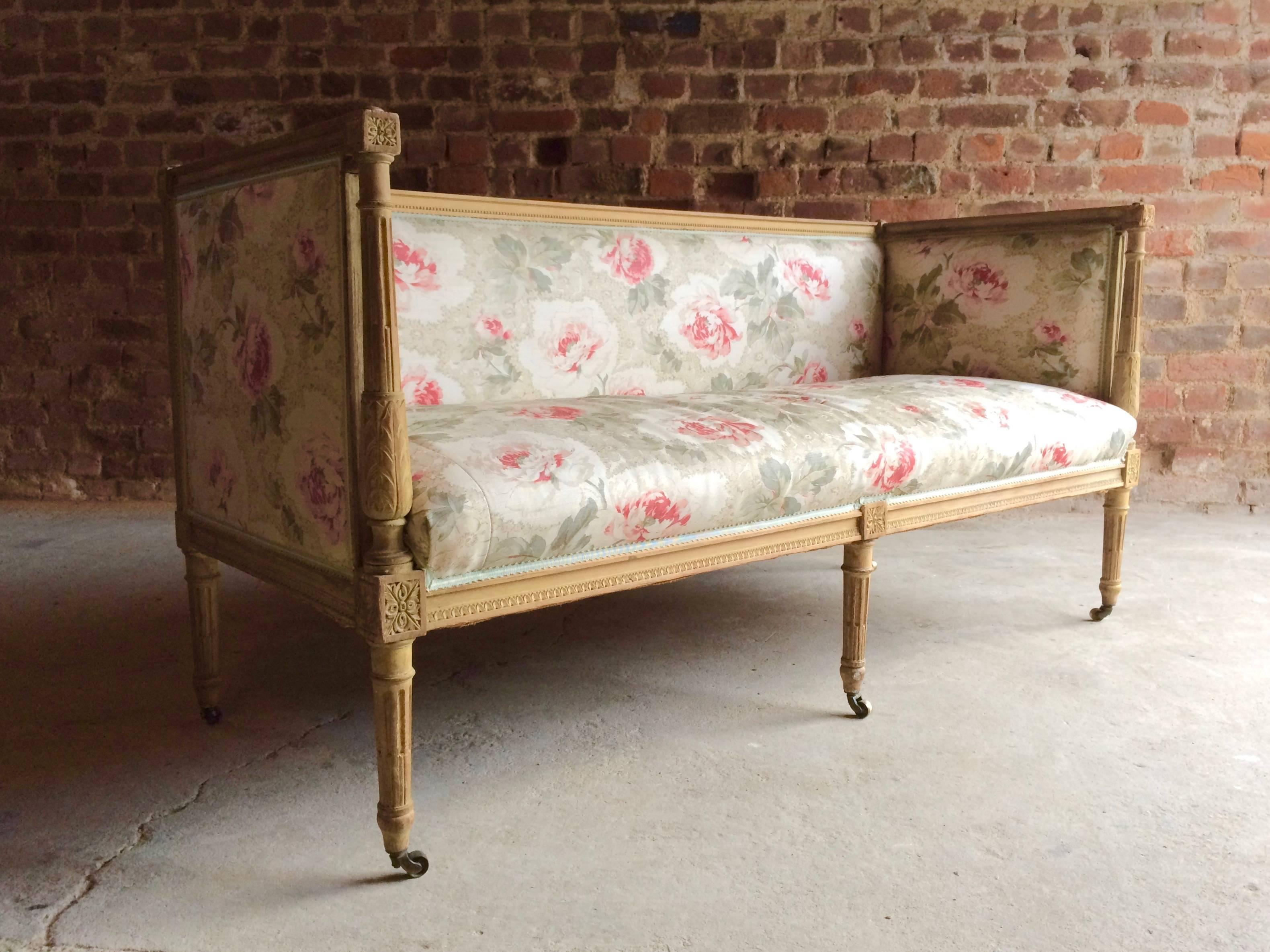 A magnificent 18th century French Louis XV beech framed salon sofa settee circa 1770, with carved and fluted outset pilaster columns to the front and turned tapering legs terminating in brass casters, upholstered in Bennison fabric, the sofa is